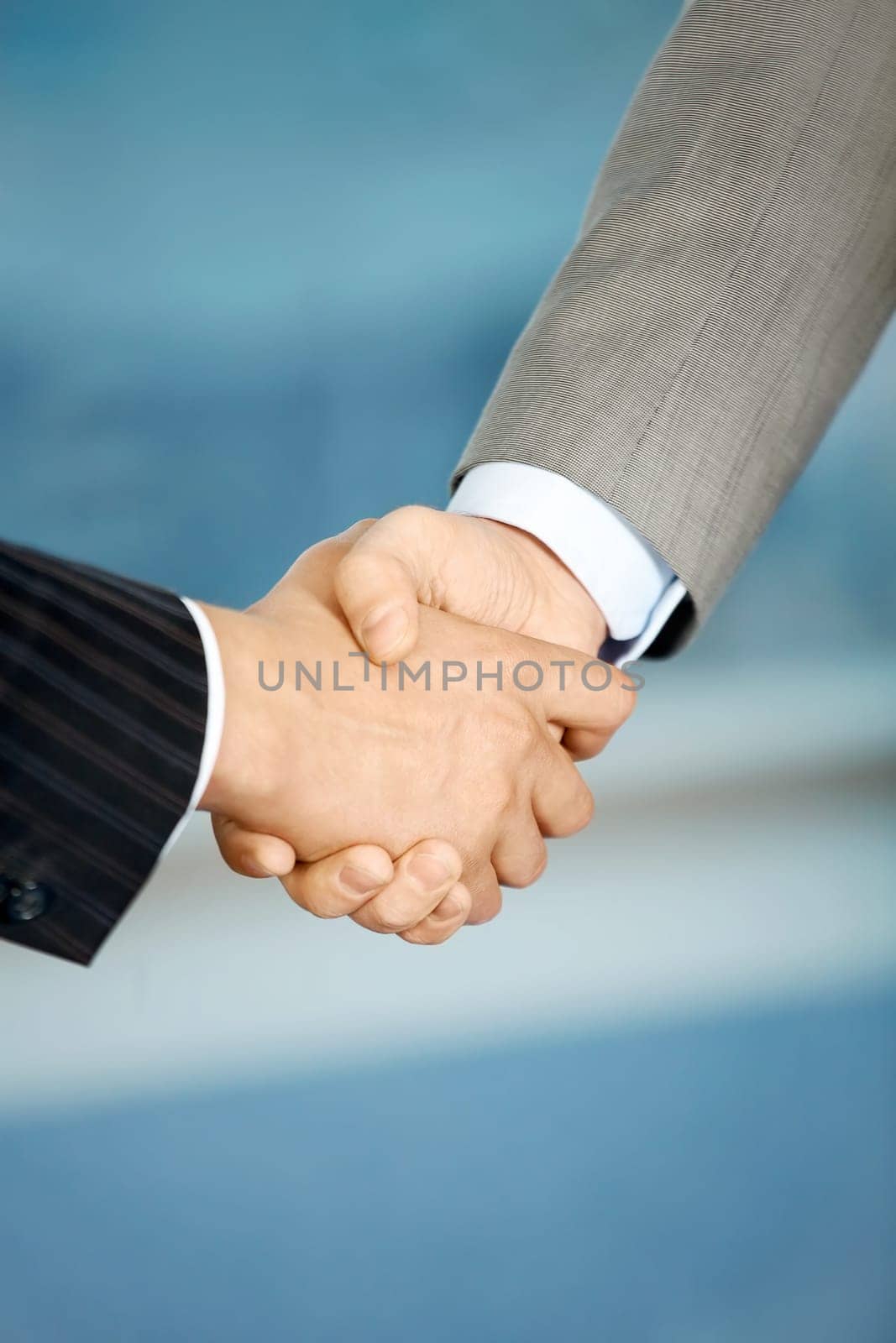 Close up of the businessmen shaking hands each other
