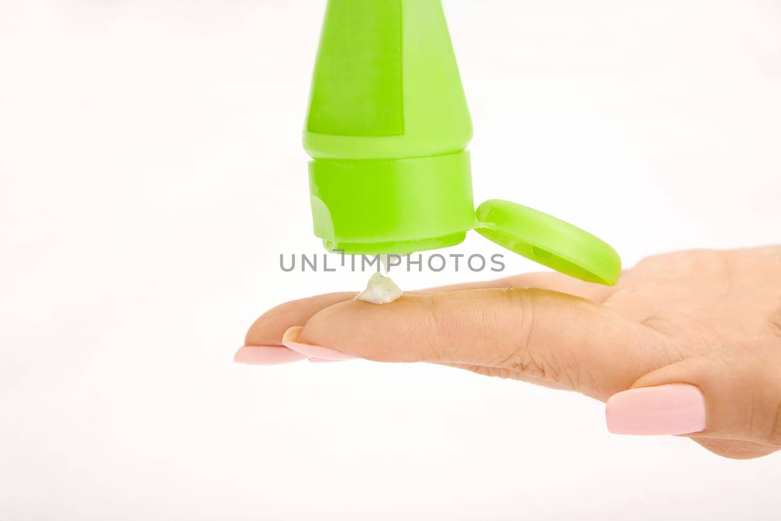 Female hand and cream from a tube, isolated