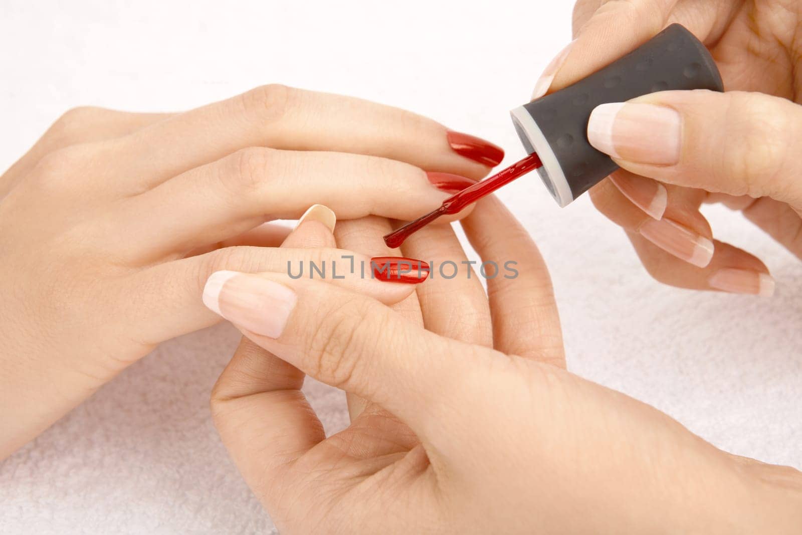 Close up - drawing of a red varnish on the nails, isolated