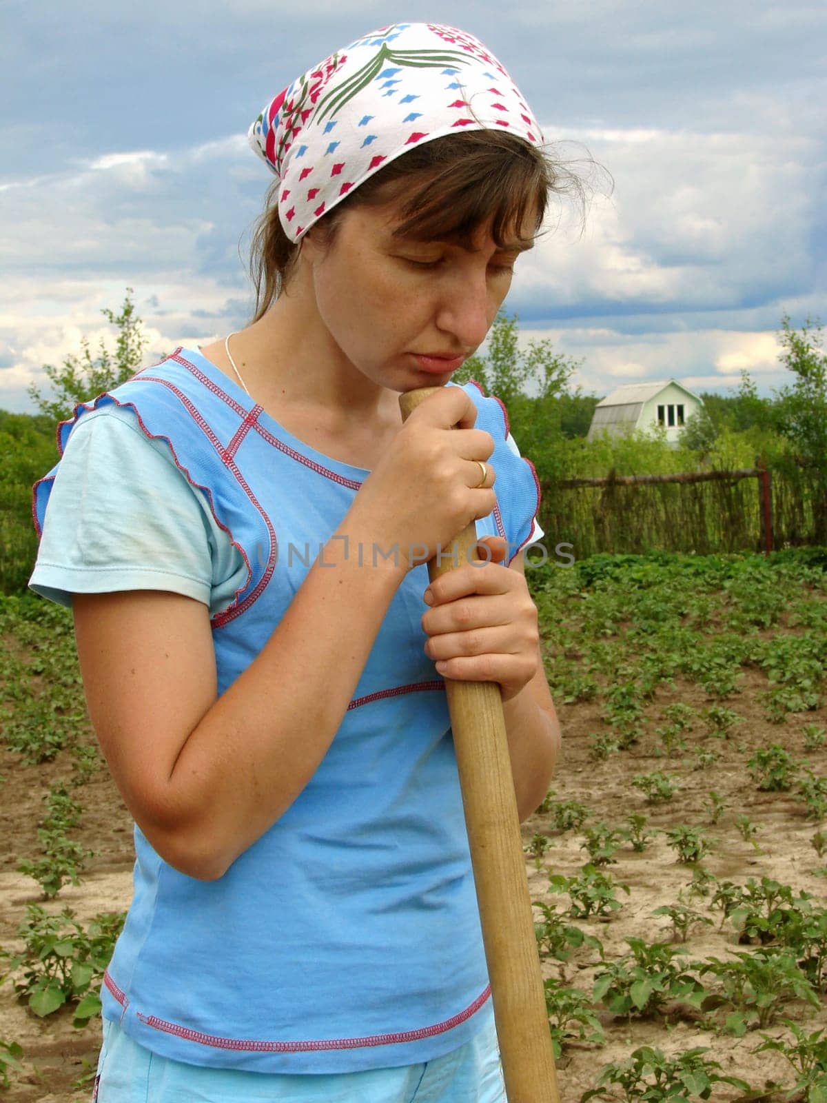 woman with gardening tool working at the farm