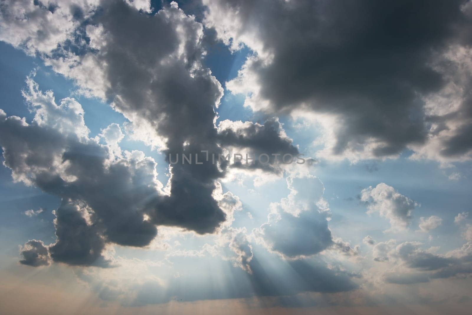 Light rays brightly shining through the clouds