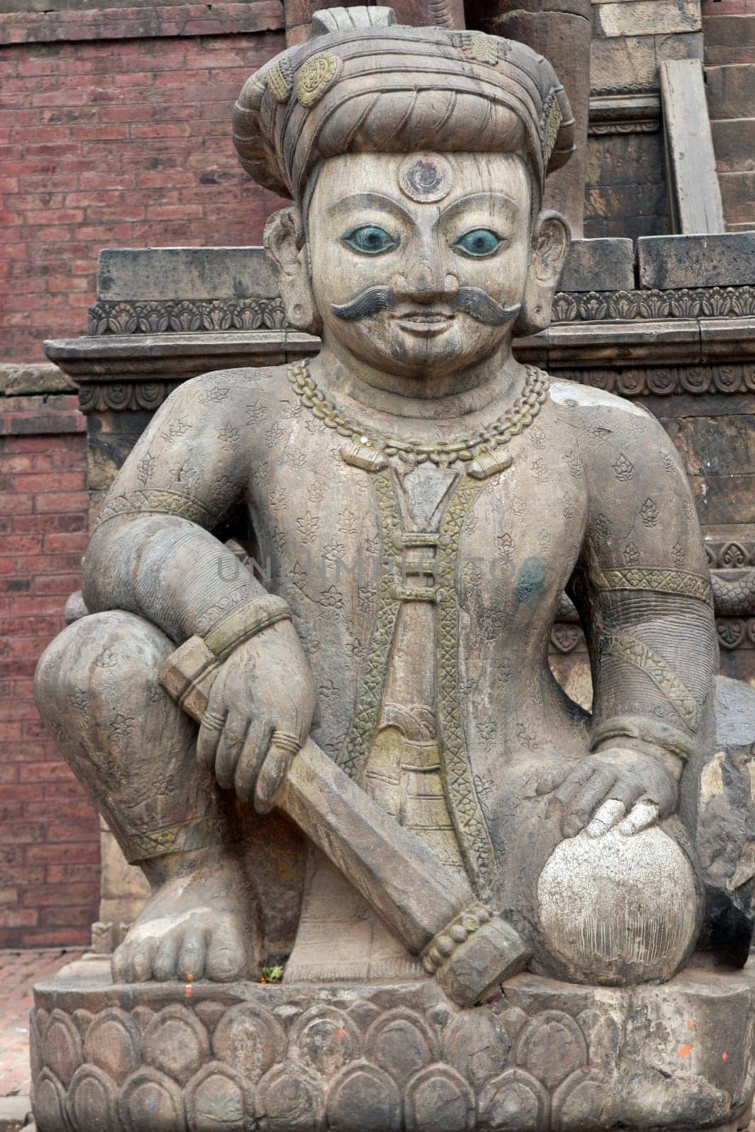 Statue of mythical person guarding the steps of the ancient Nyatopola Temple in Bhaktapur, Nepal