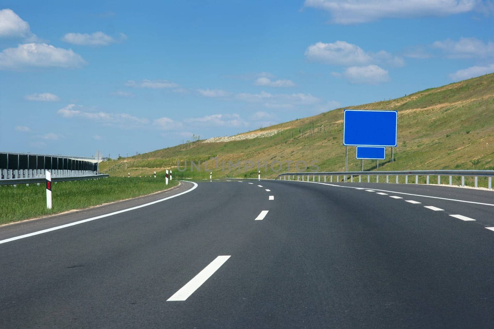 Empty highway lanes bending view from close