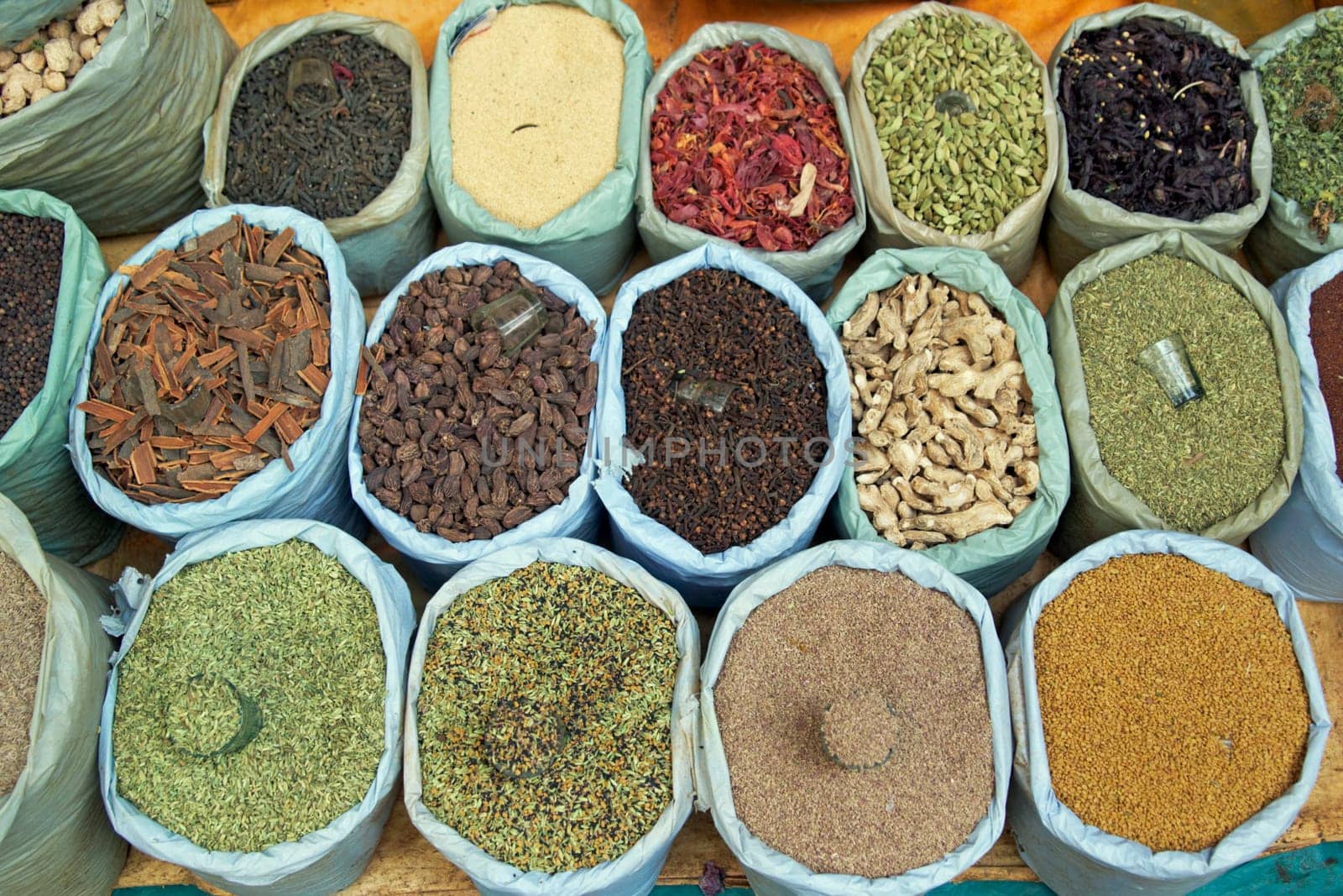 Colorful arrangement of spices for sale at a market stall in Old Delhi, India