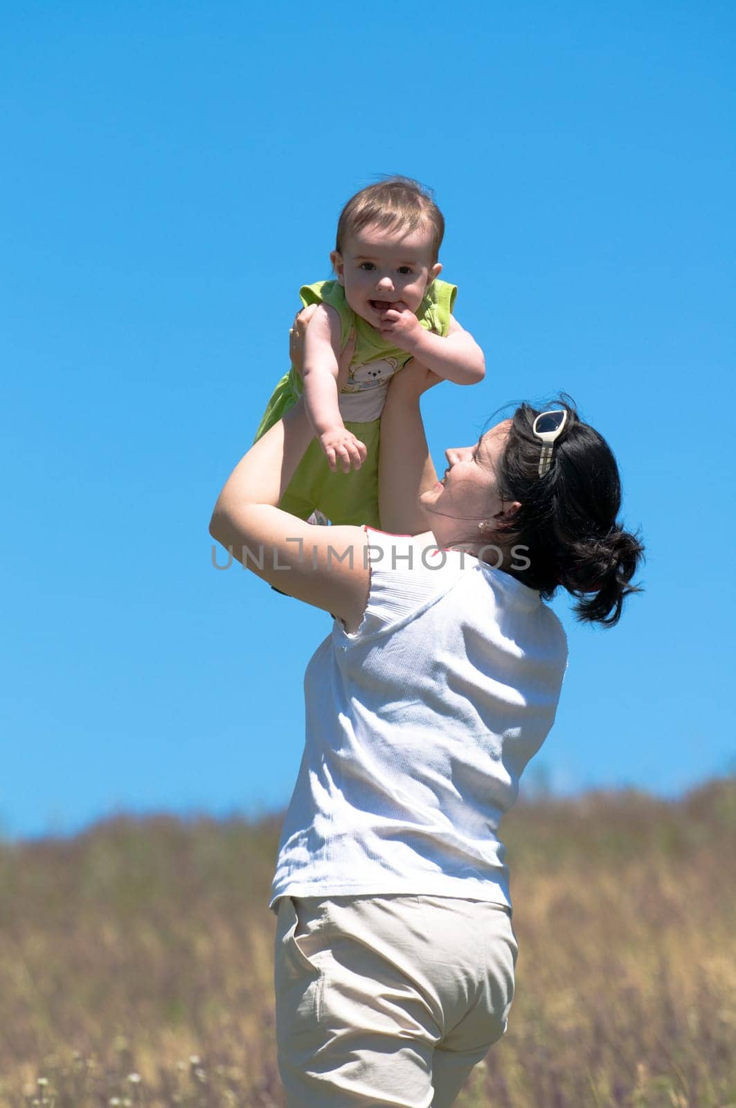 a mummy is playing with his little son outdoors