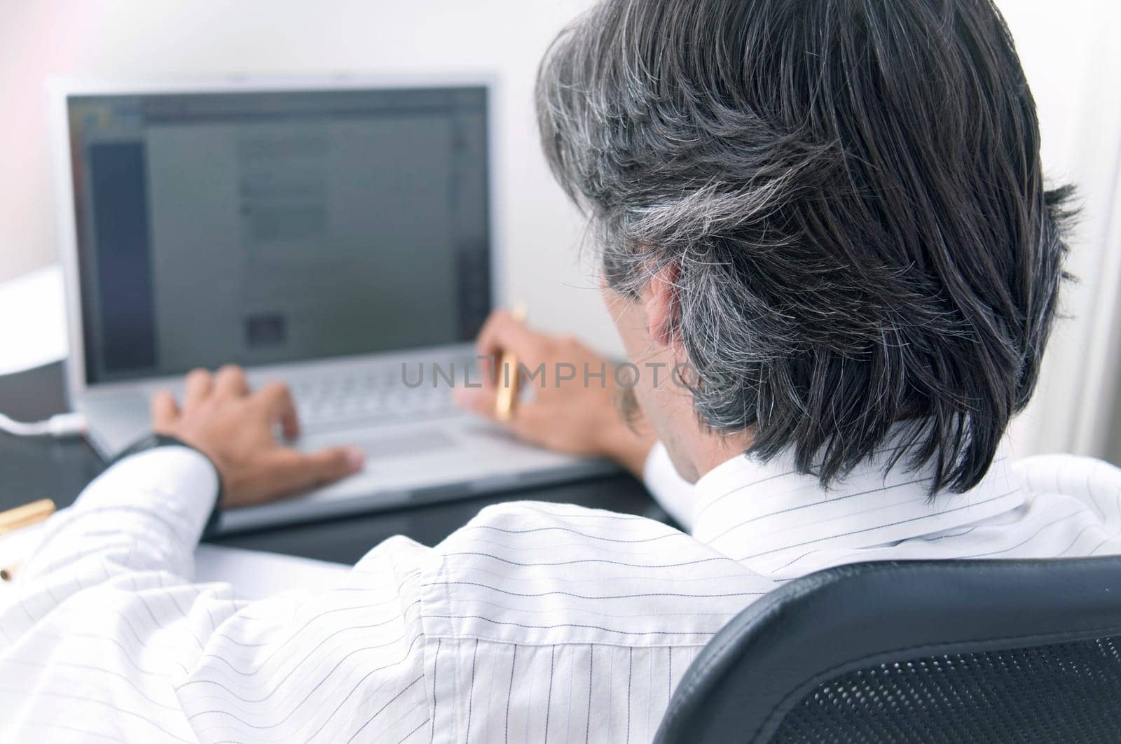 A businessman working on the computer at his desk