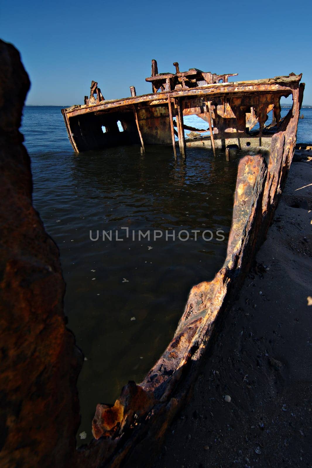 A sunken shipwreck rusting into the ocean