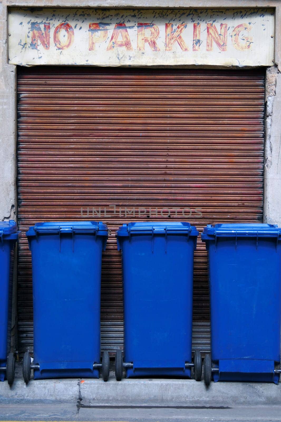 Blue garbage bins in a row