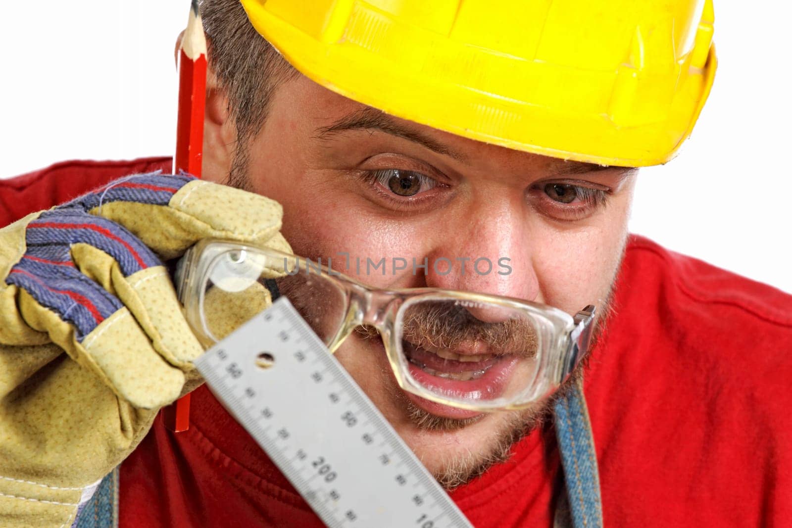 young caucasian handyman check misure on his intrument