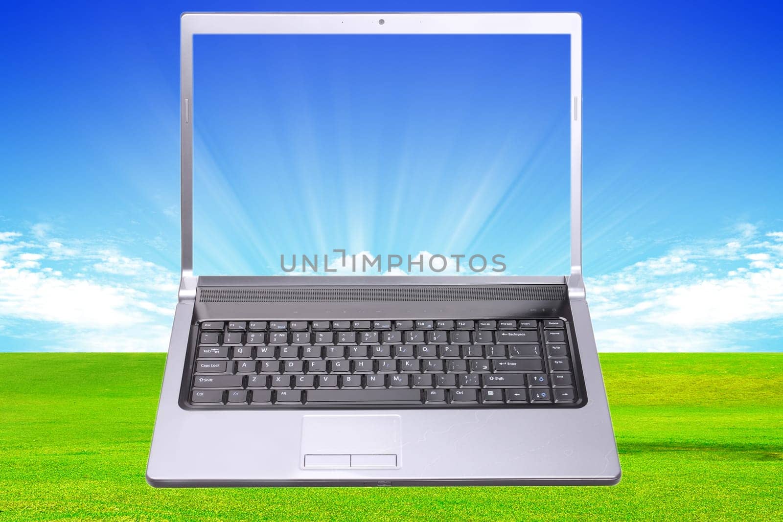 Modern notebook with grass and clouds background