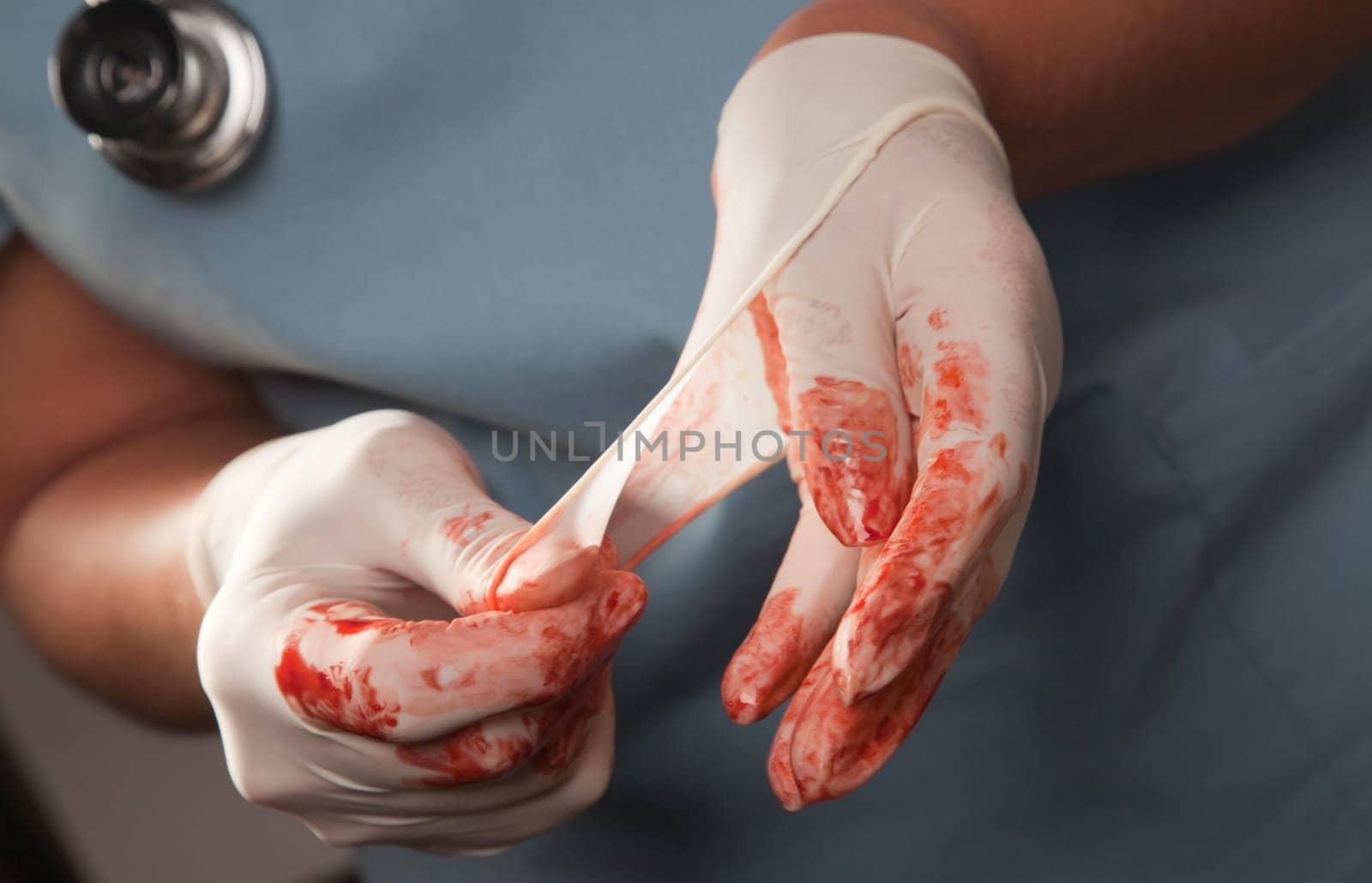 Abstract of Doctors Bloody Surgical Gloves, Scrubs and Stethoscope.