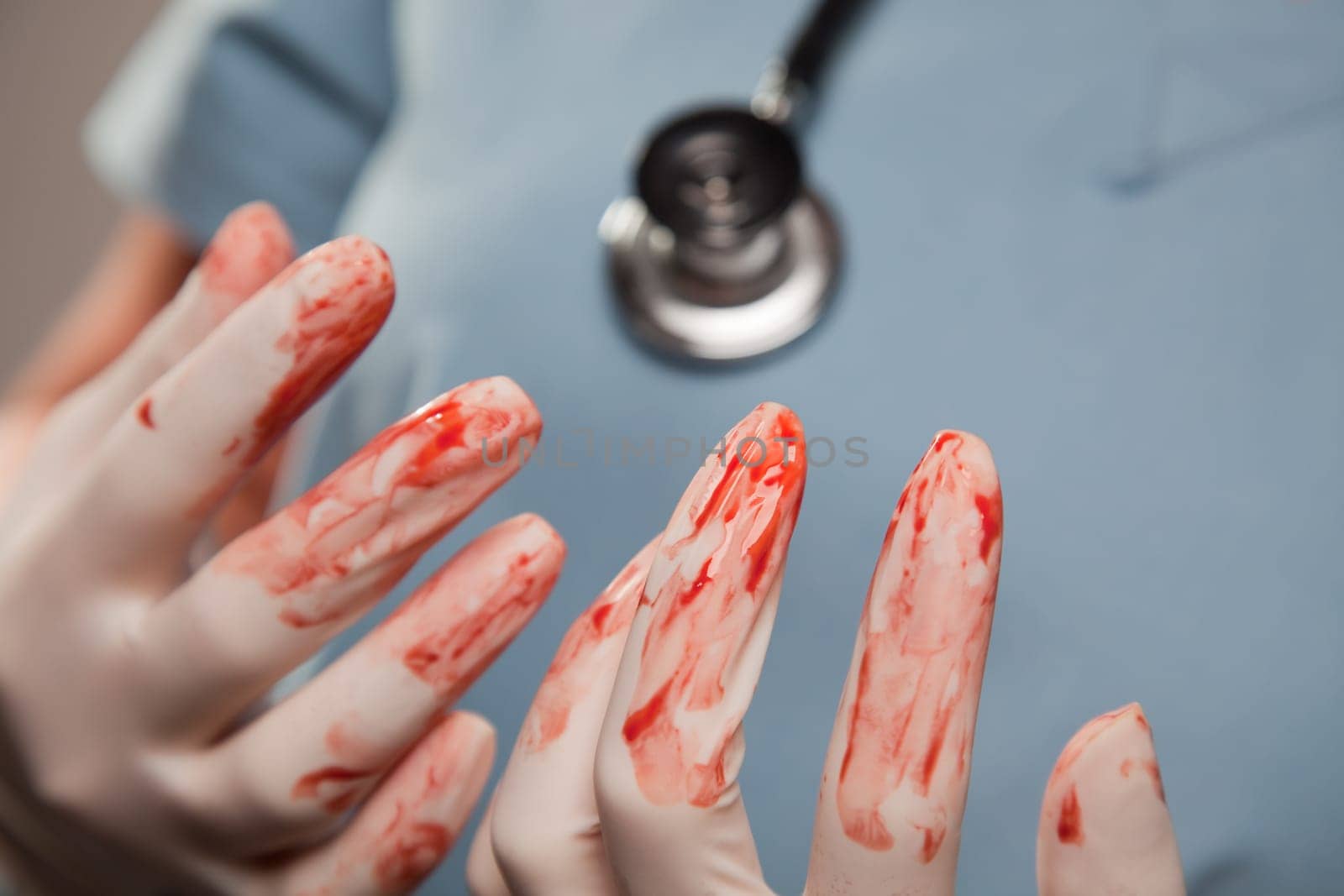 Abstract of Doctors Bloody Surgical Gloves, Scrubs and Stethoscope.