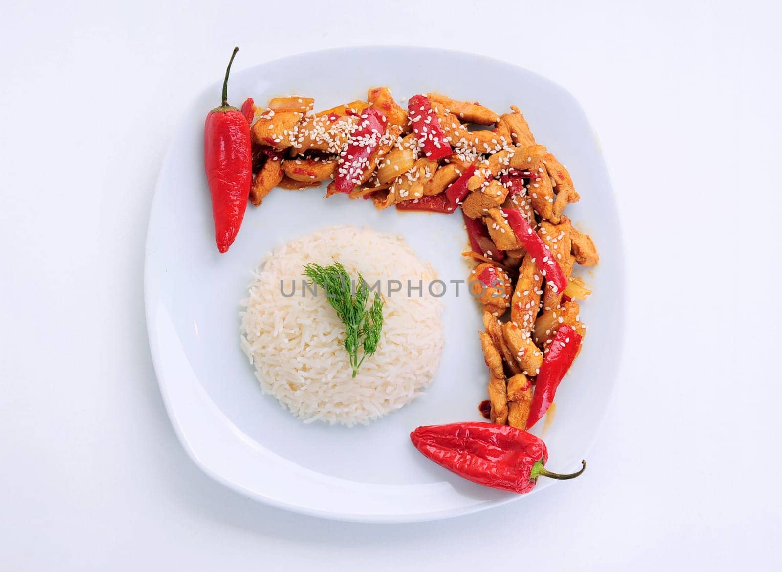 2 red pepper chicken  and rice with dill in white plate