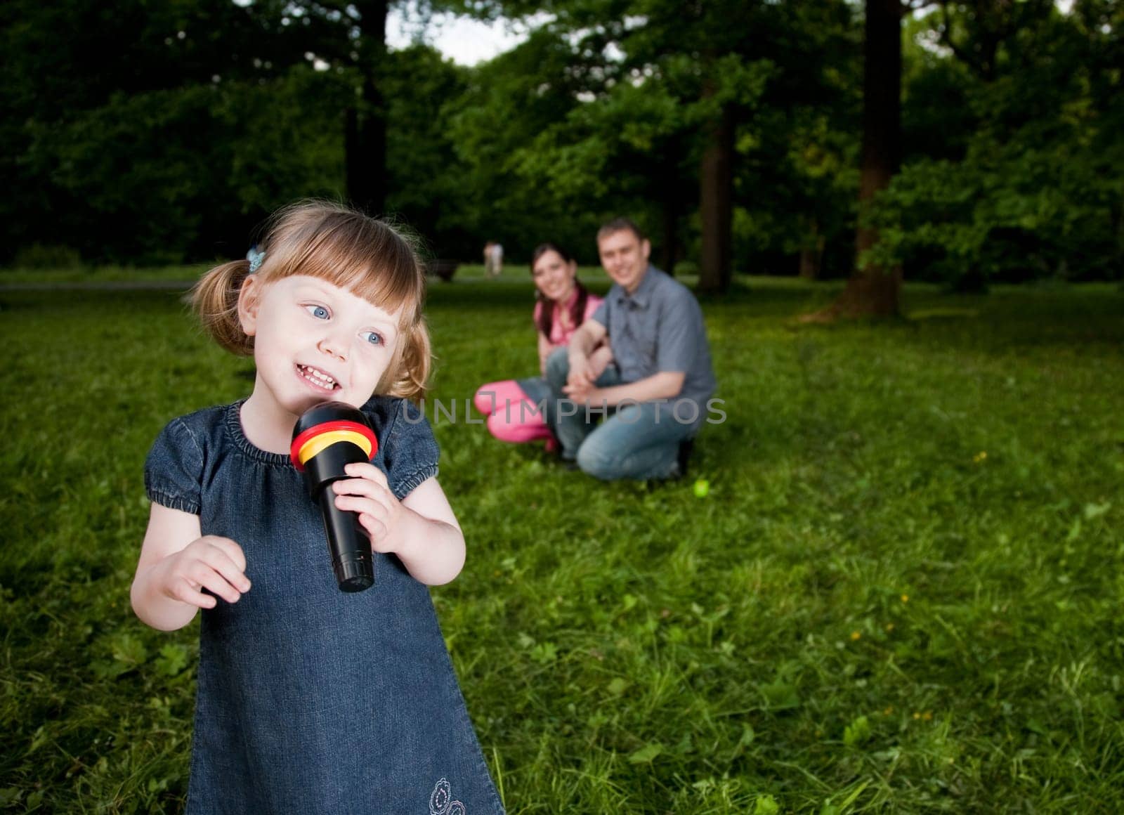Little Girl With Microphone In Hand