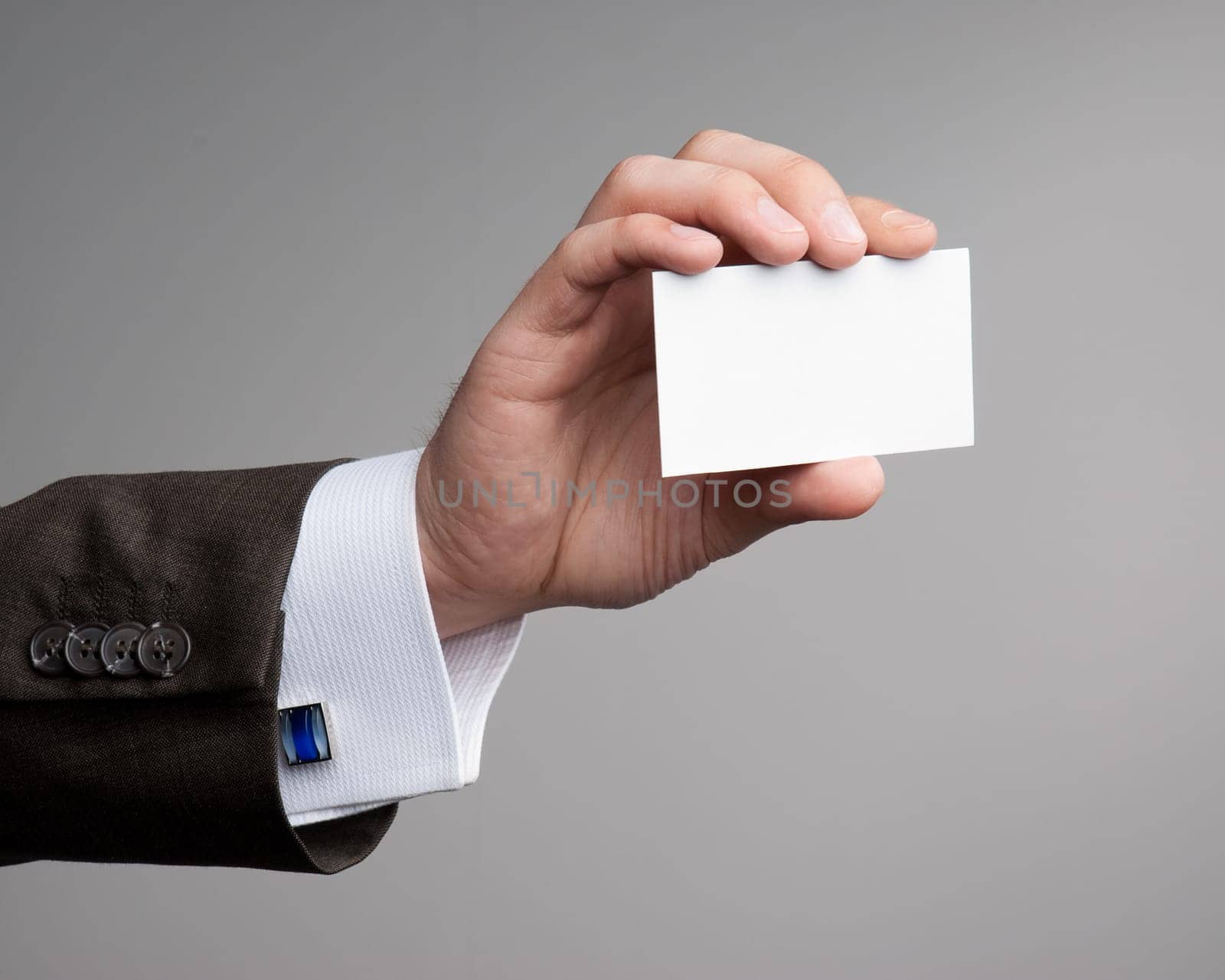 White visit card in hand isolated in studio