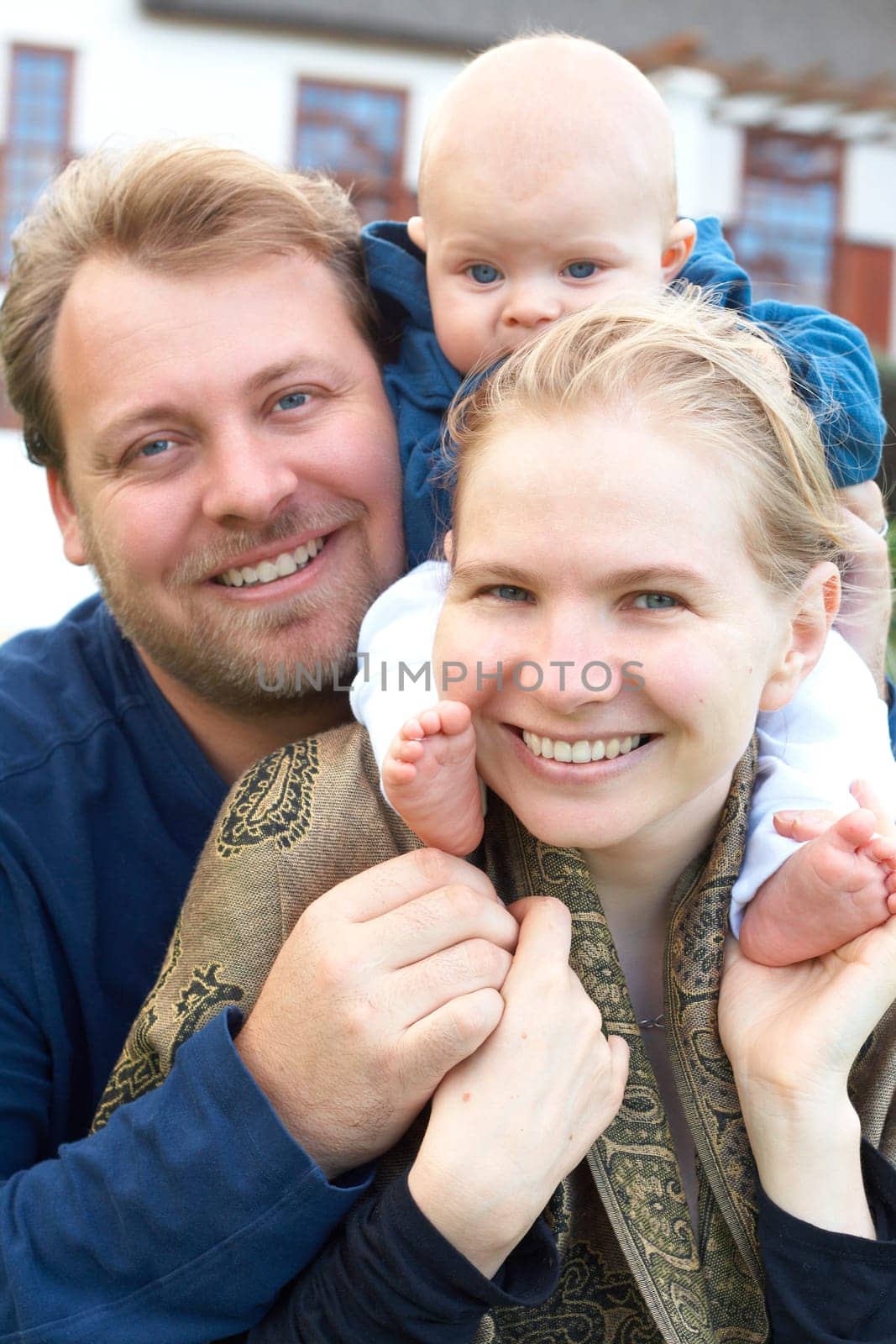 Beautiful happy family of three laughing. Focus is on the mother