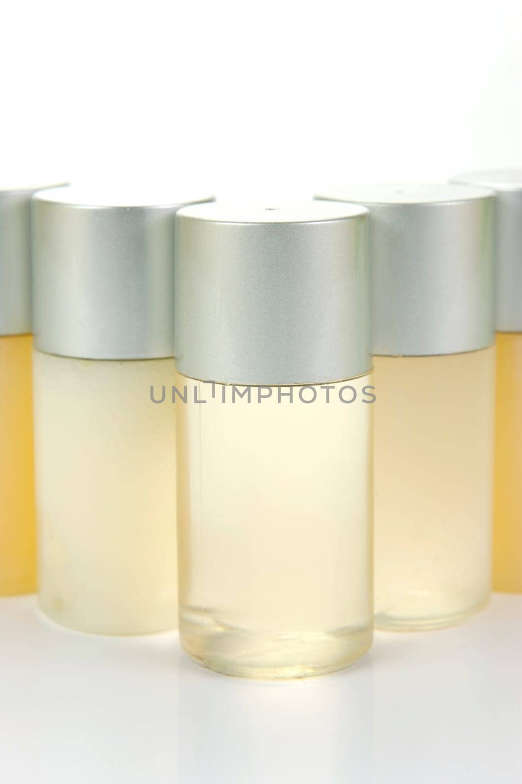 Miniatureshampoo bottles isolated against a white background