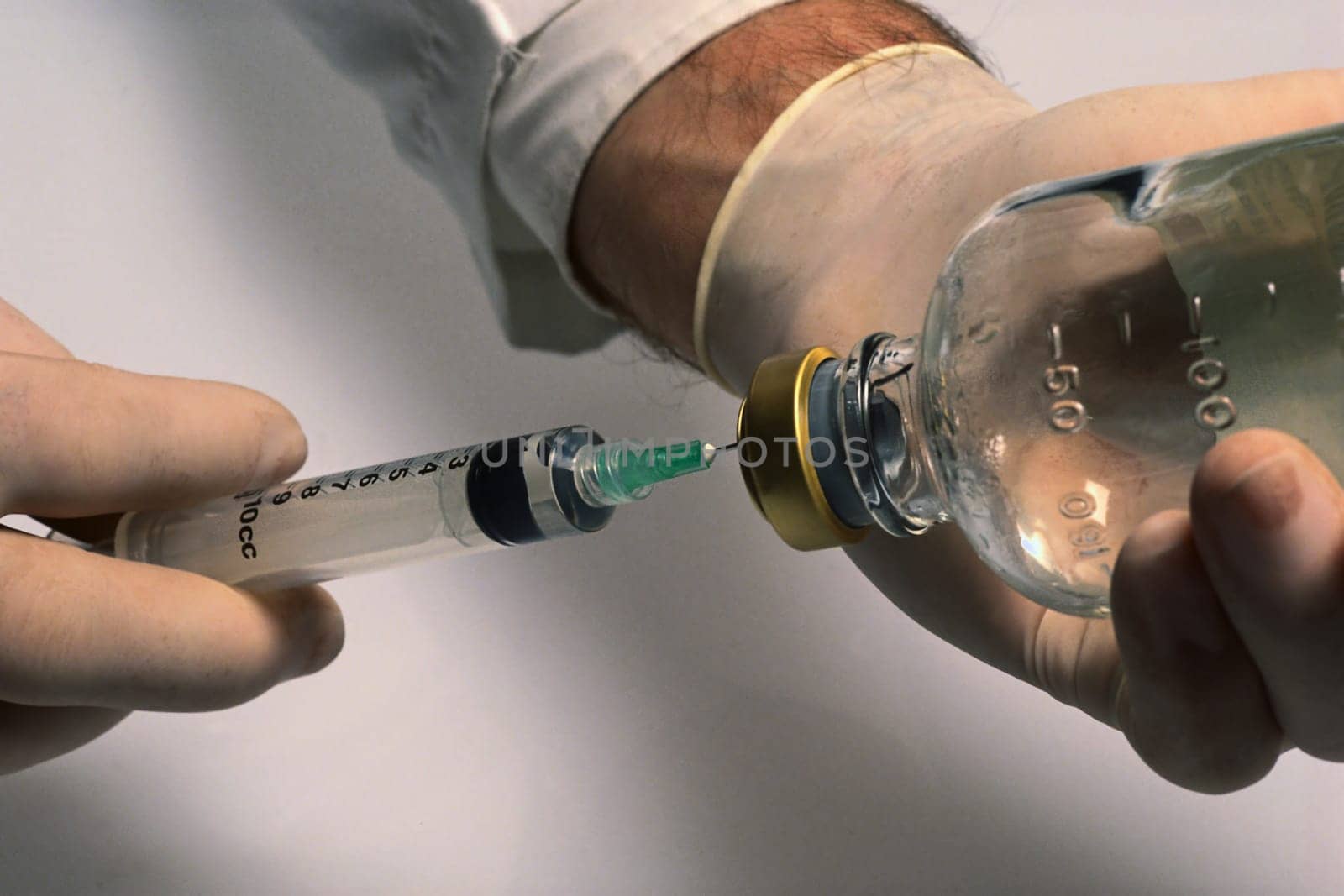 man with syringe and with a bottle