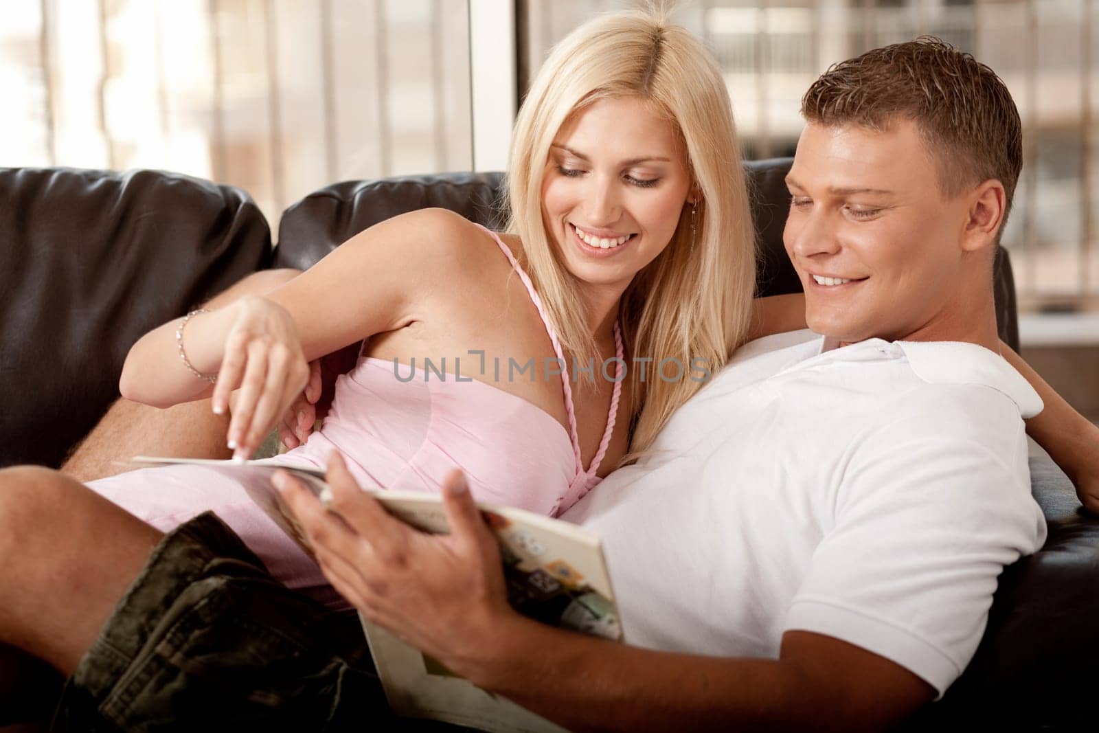 Couple reading a book and smiling