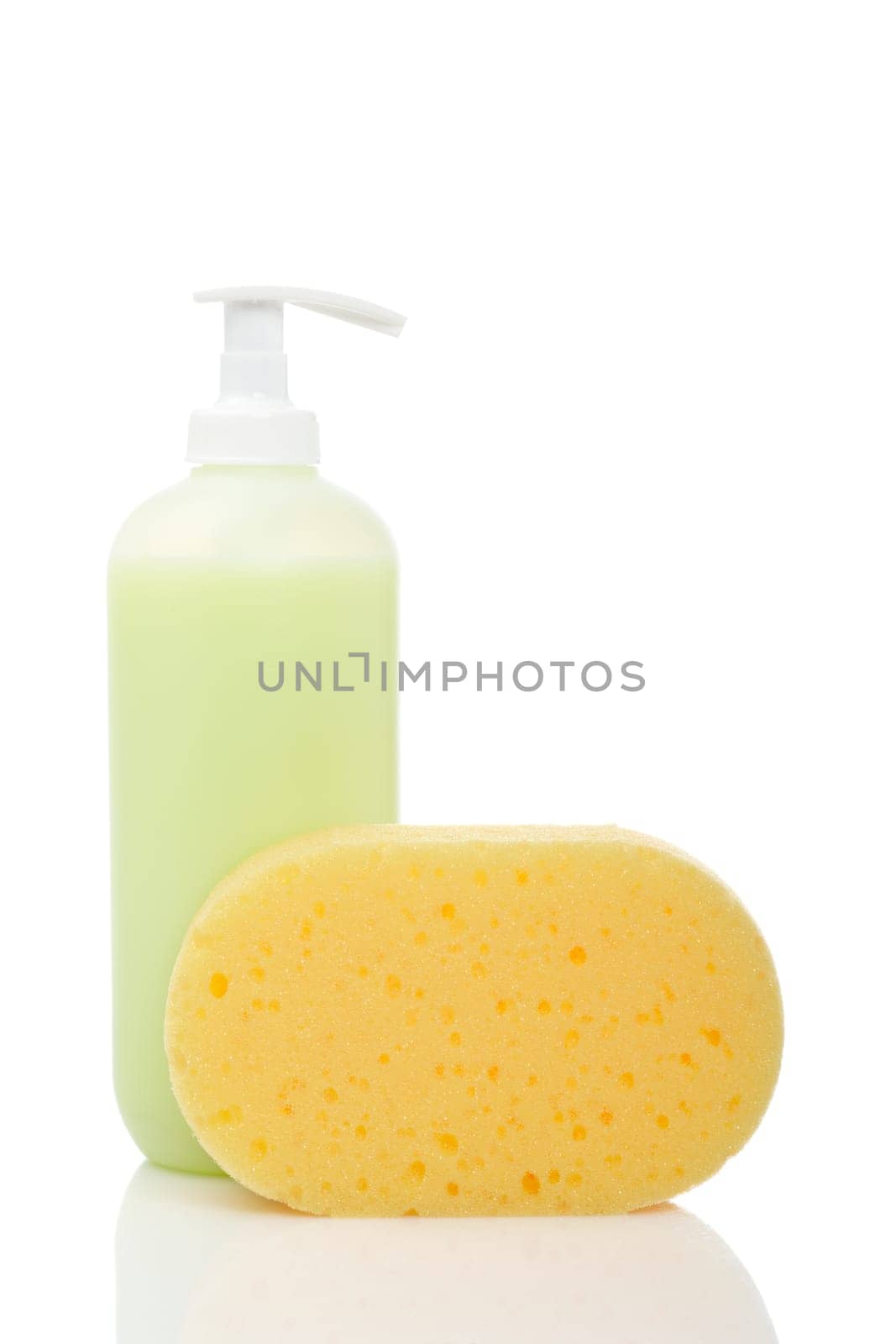 Plastic pump soap bottle and sponge reflected on white background