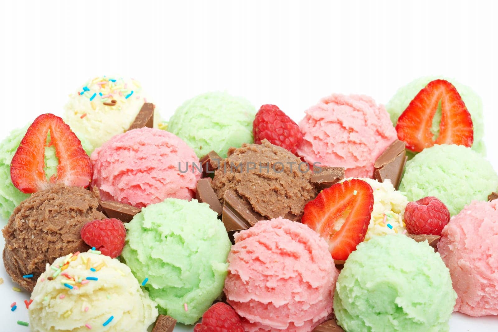 Delicious ice cream balls and sliced strawberry. Shallow depth of field