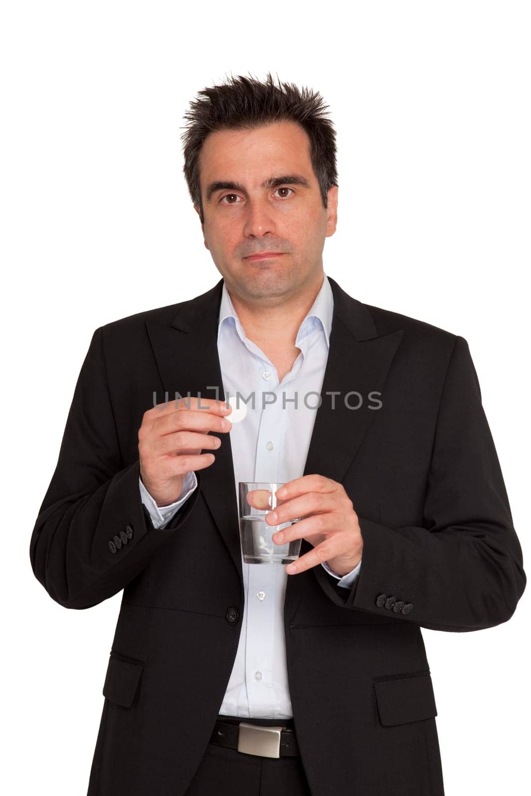 Young businessman keeps in his hands one bubble pill and a glass of water
