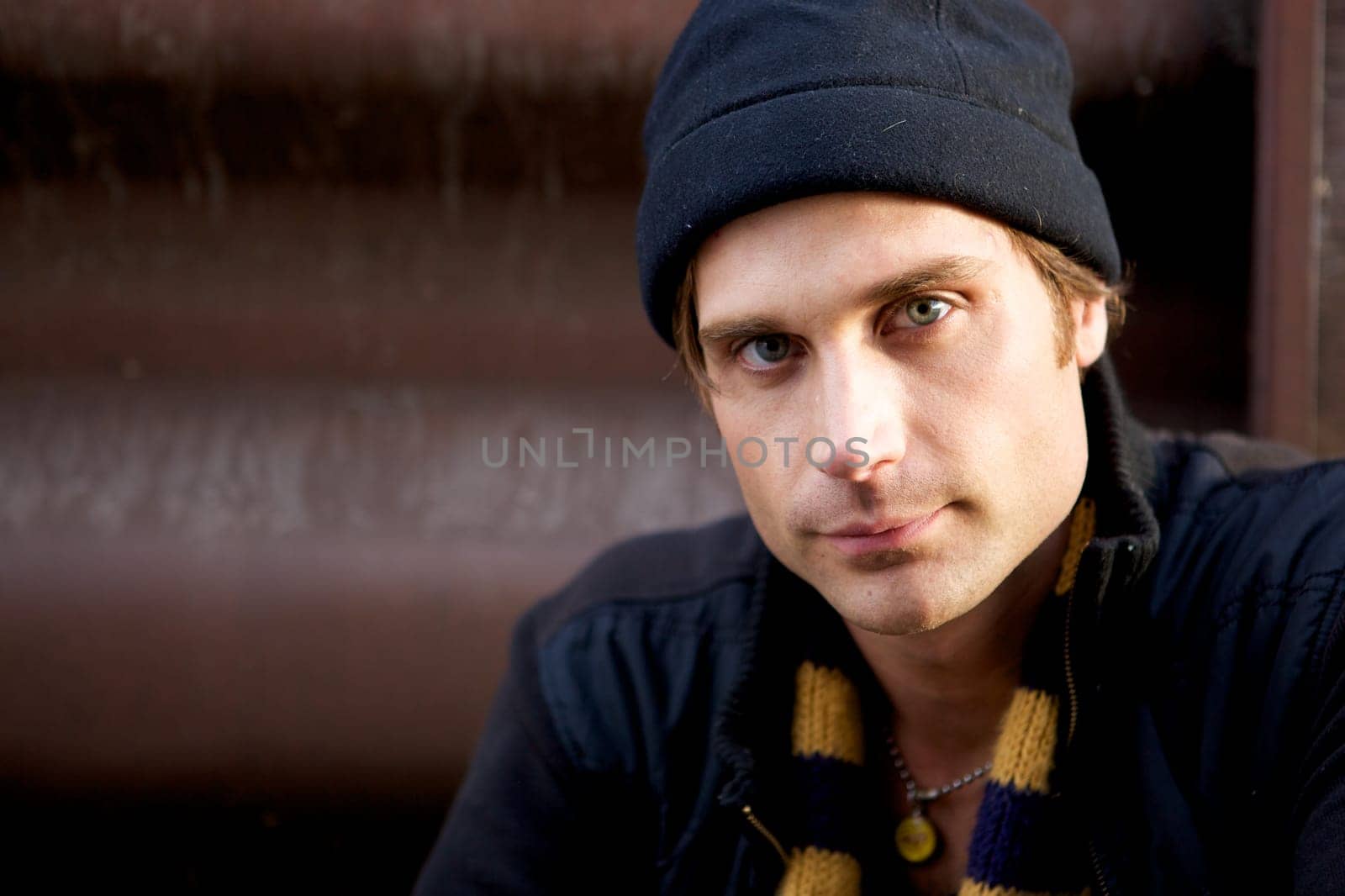 A beautiful young man with a cap and a scarf