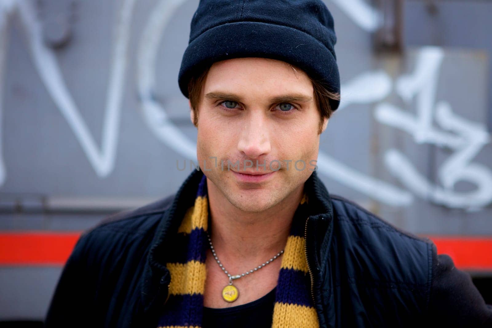 A beautiful young man with a cap and a scarf