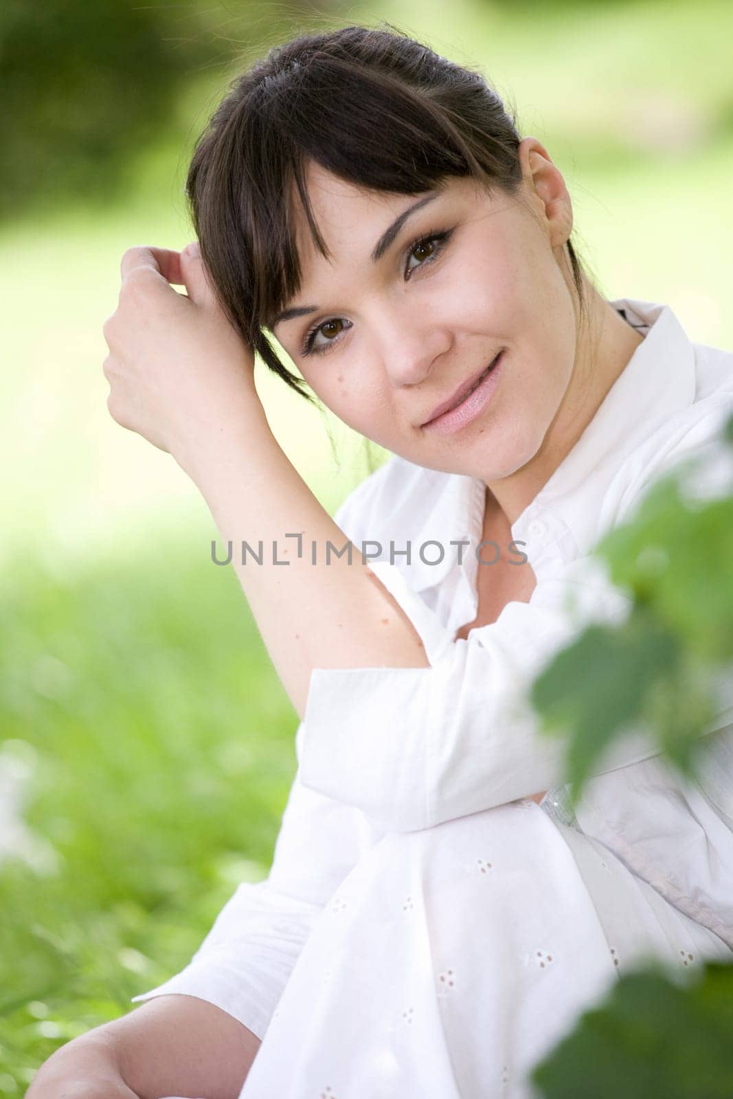attractive brunette woman relaxing in park