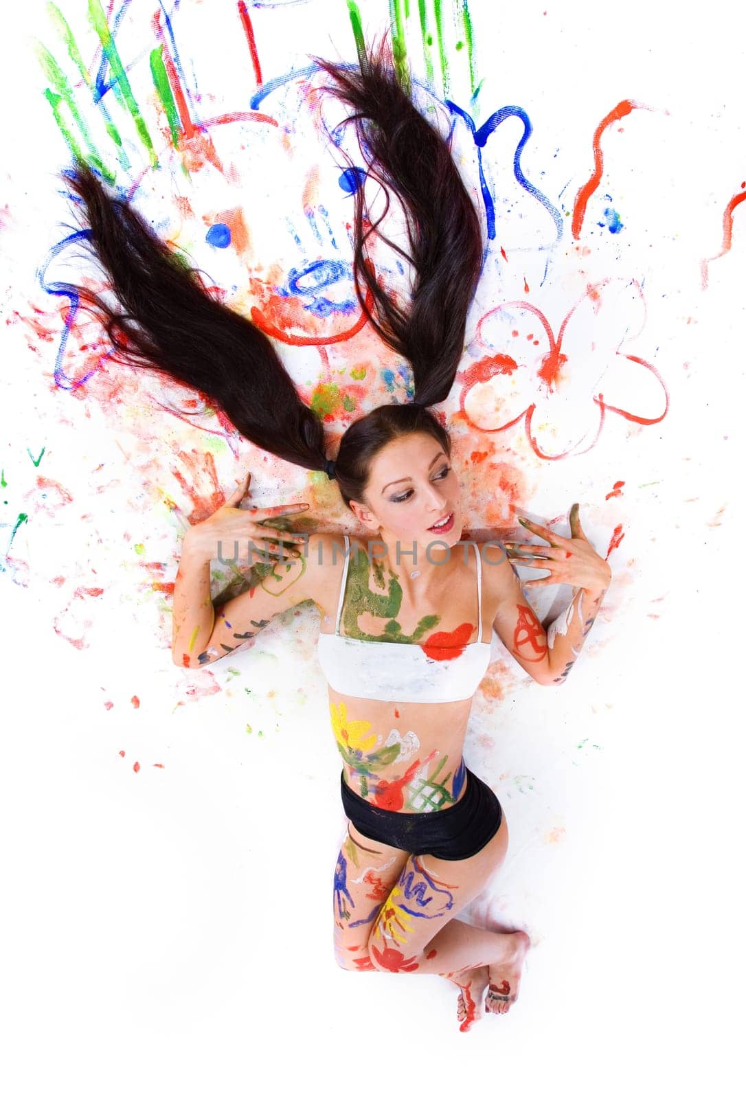 Beautiful girl paints on a white background