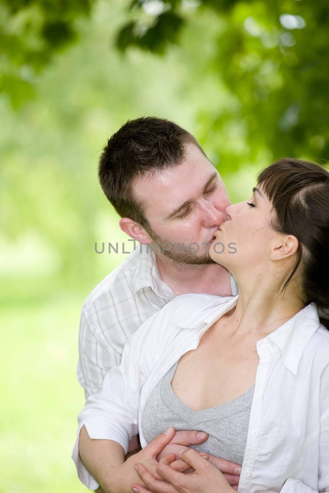 happy young couple relaxing in park