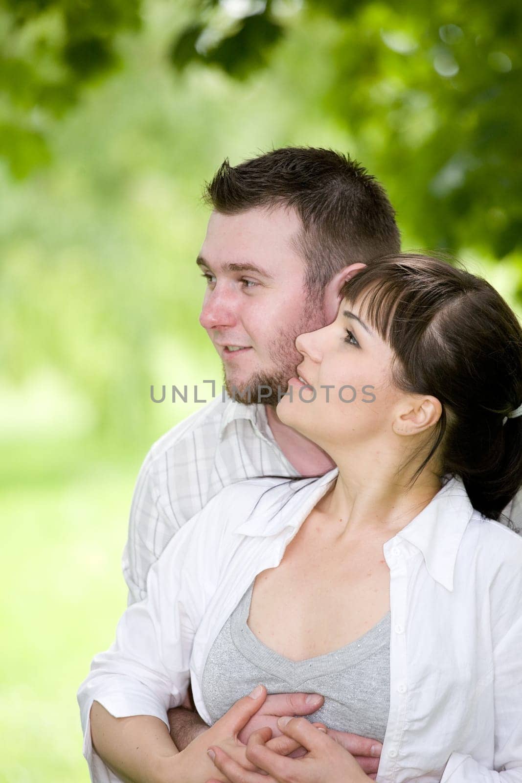 happy young couple relaxing in park