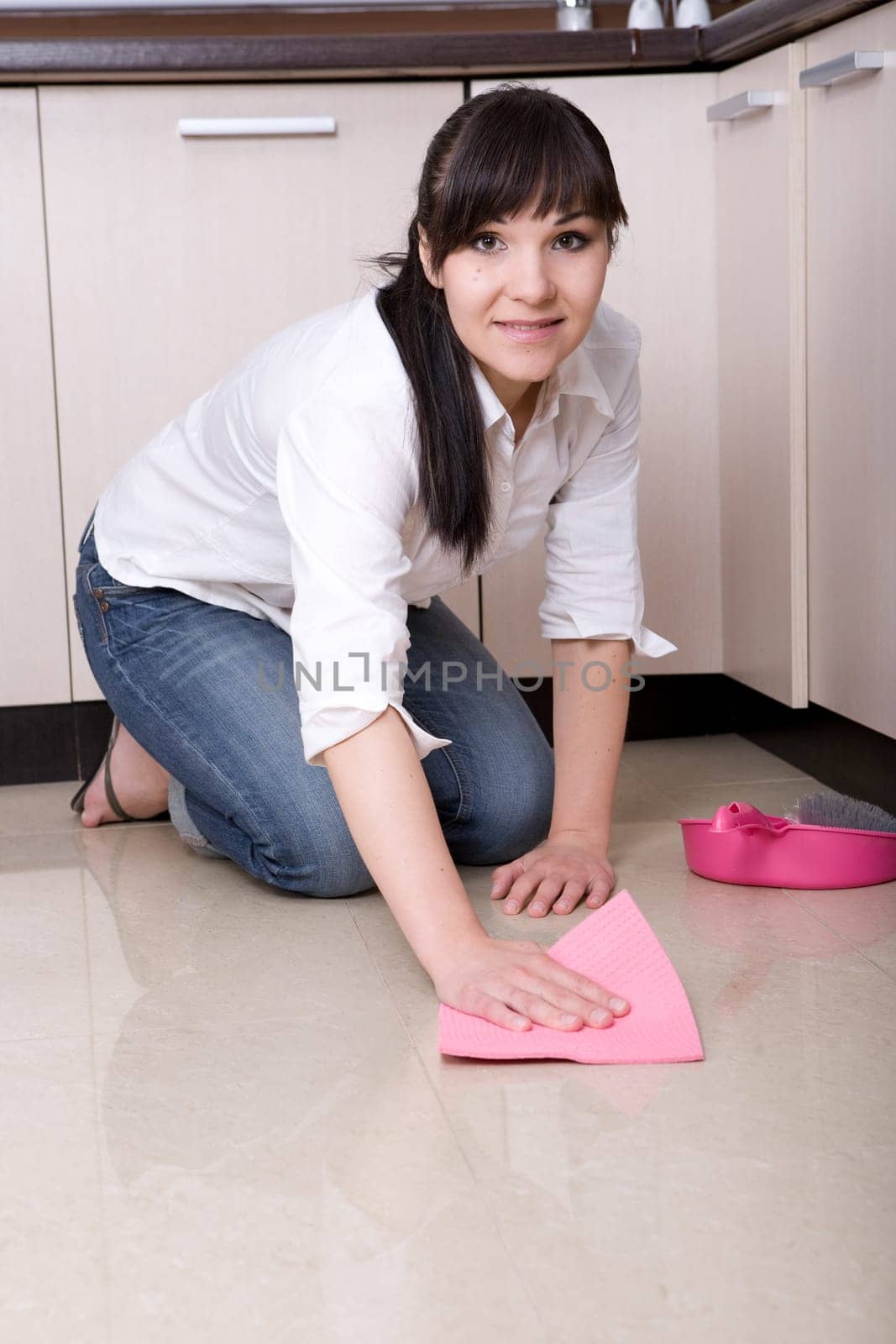 young brunette woman cleaning kitchen