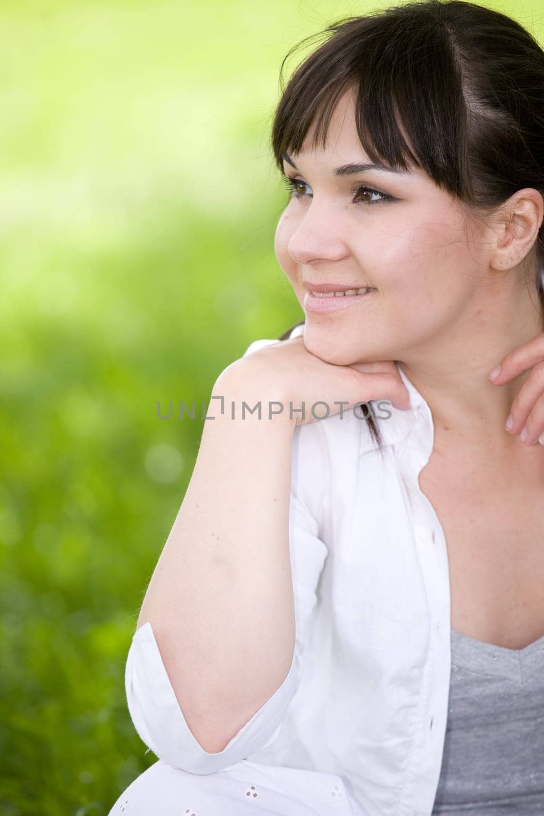 attractive brunette woman relaxing in park