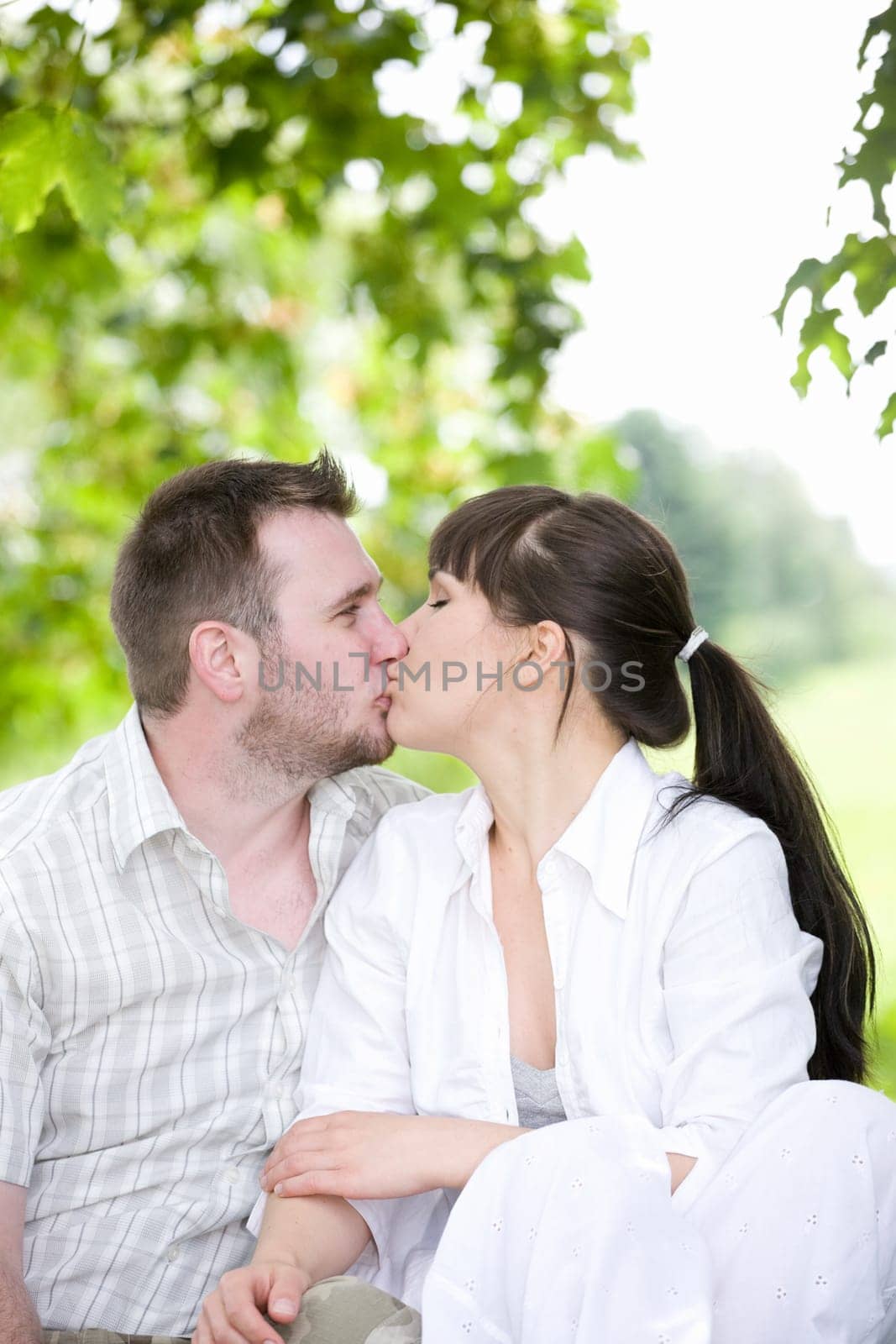 happy young couple relaxing in park