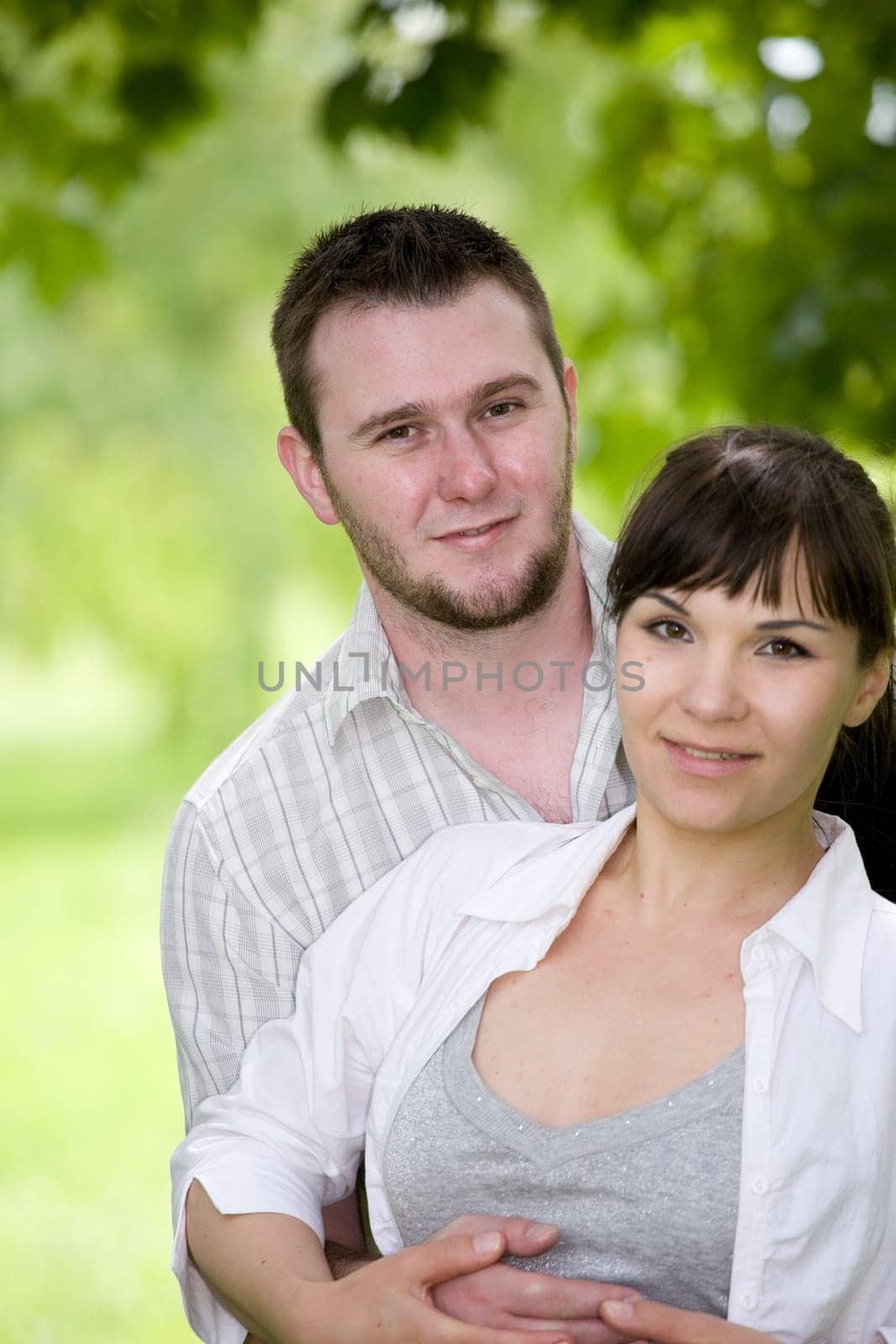 happy young couple relaxing in park