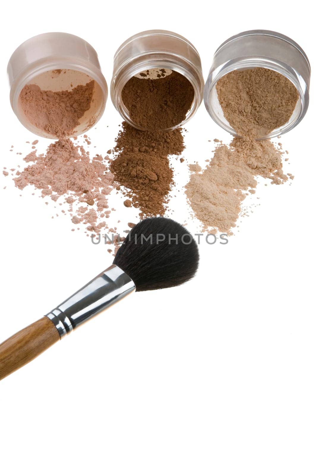 Female color cosmetics and brush for a make-up on a light background