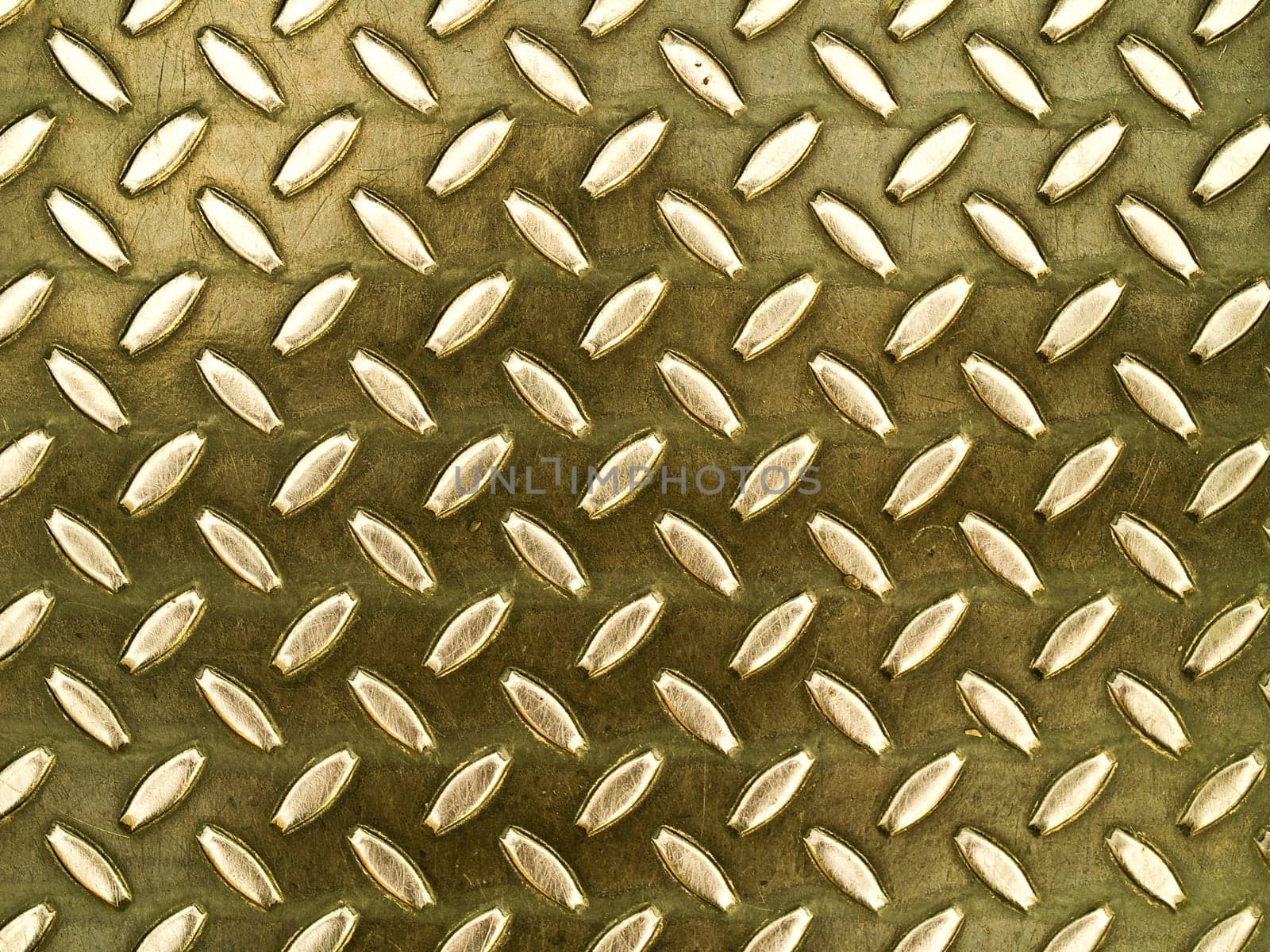 Diamond gold toned metal background texture illuminated by sunlight