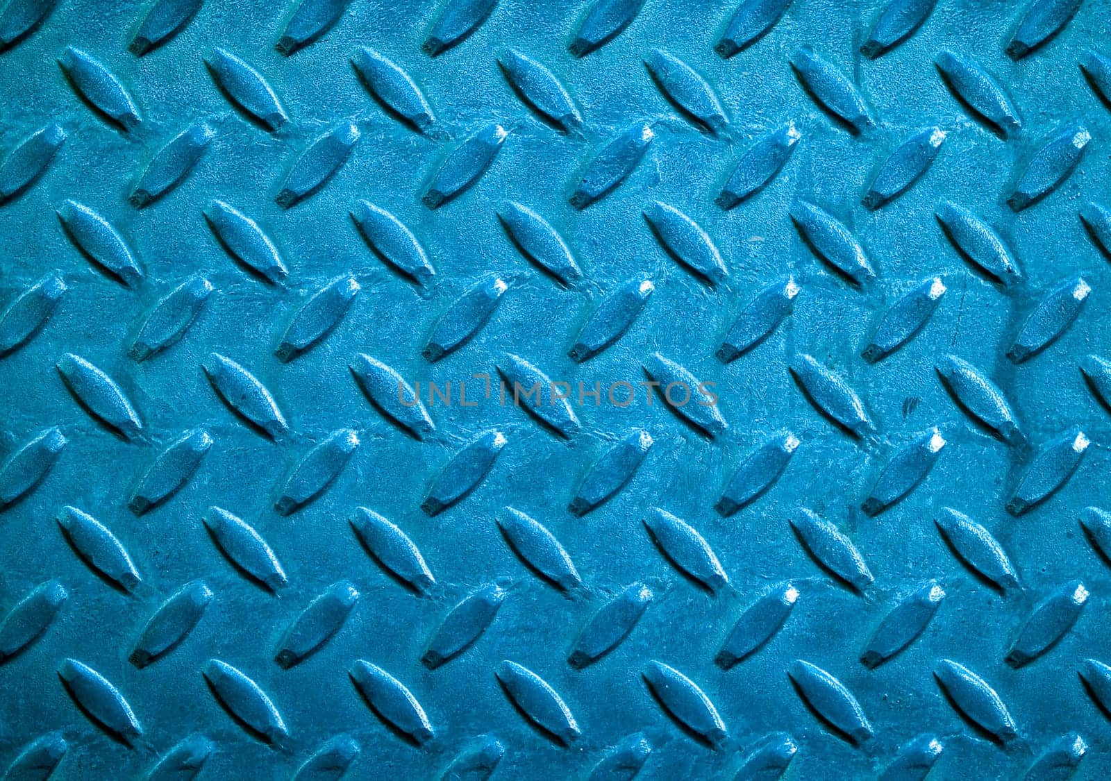 Diamond blue toned metal background texture illuminated by sunlight
