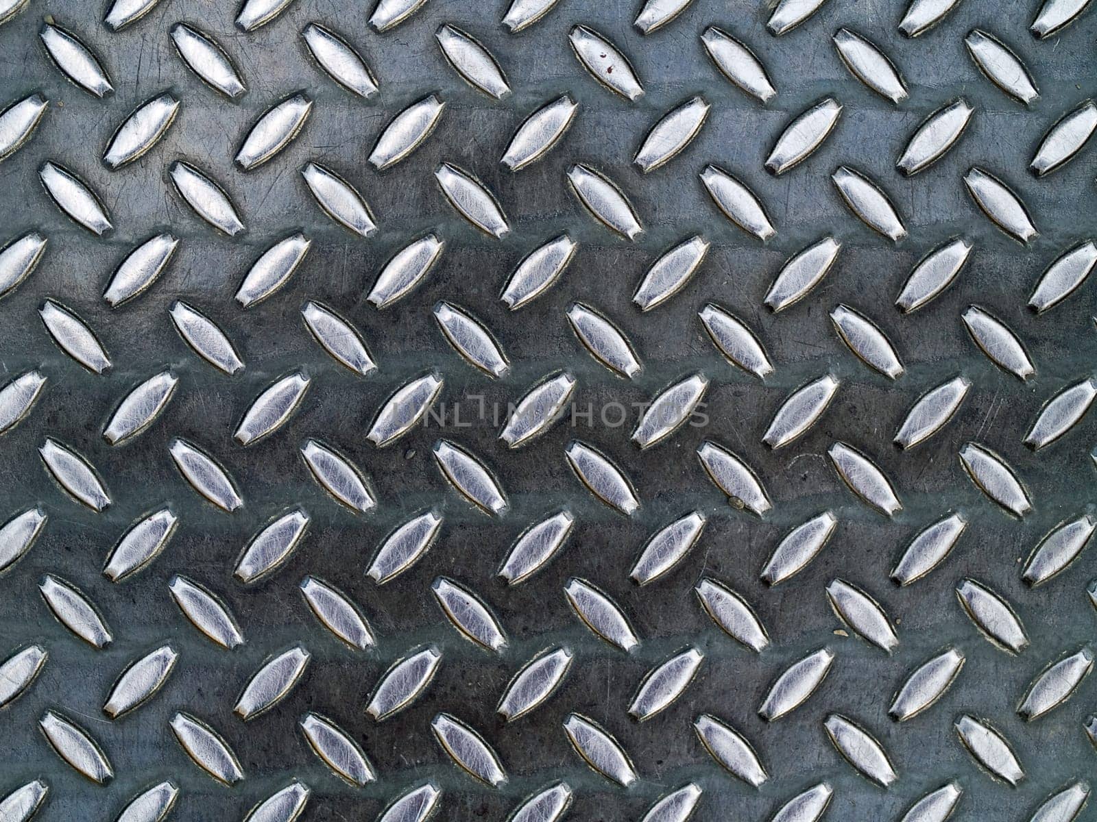 Diamond metal background texture illuminated by sunlight