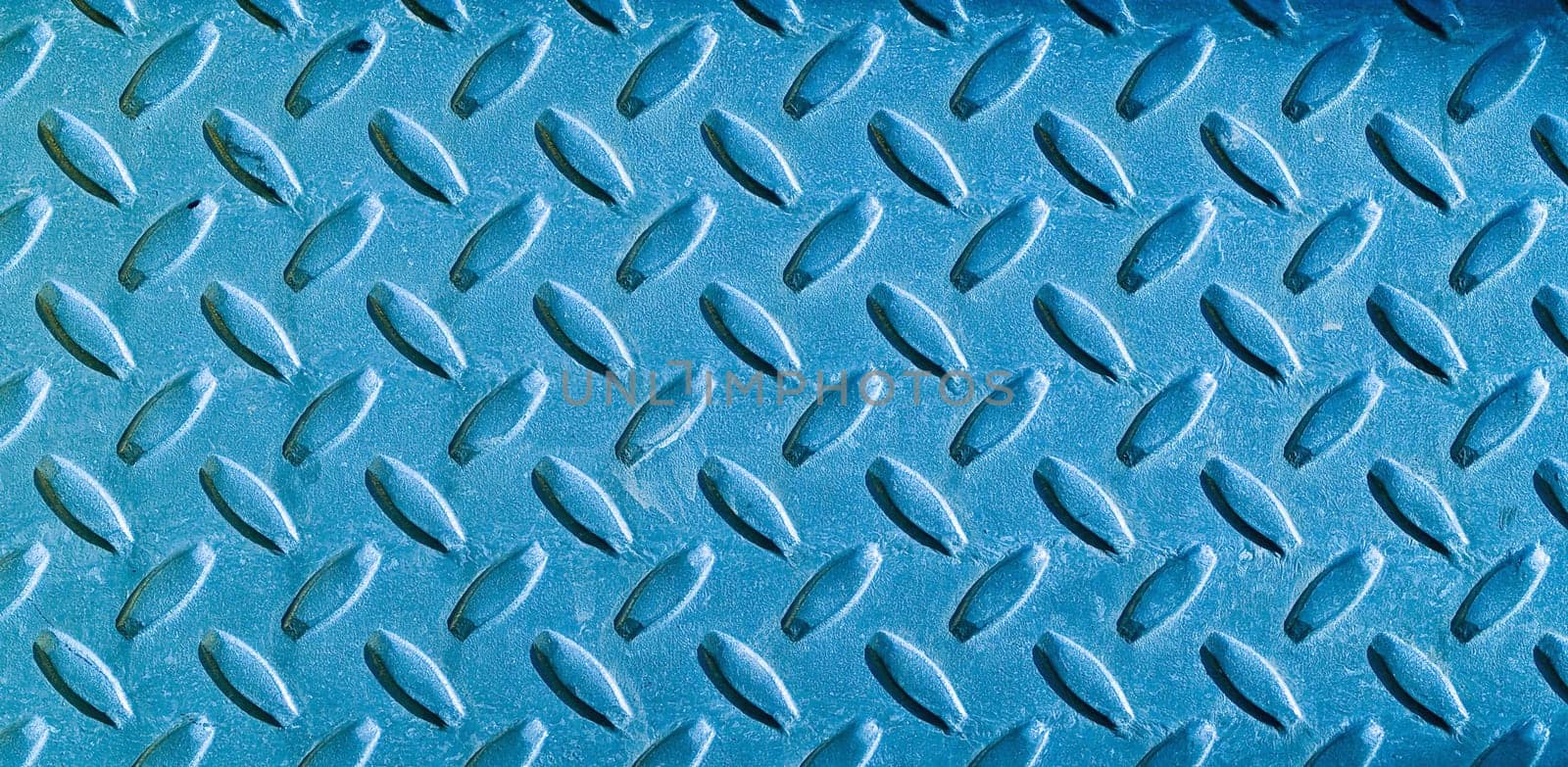 Diamond blue toned metal background texture illuminated by sunlight