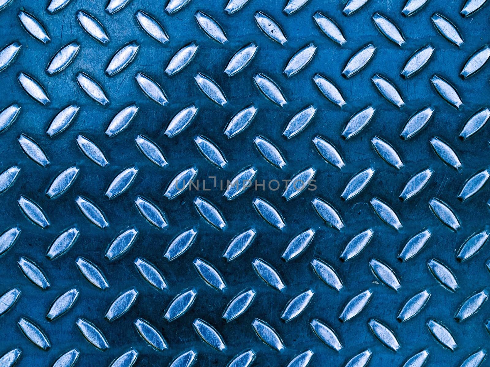 Diamond blue toned metal background texture illuminated by sunlight
