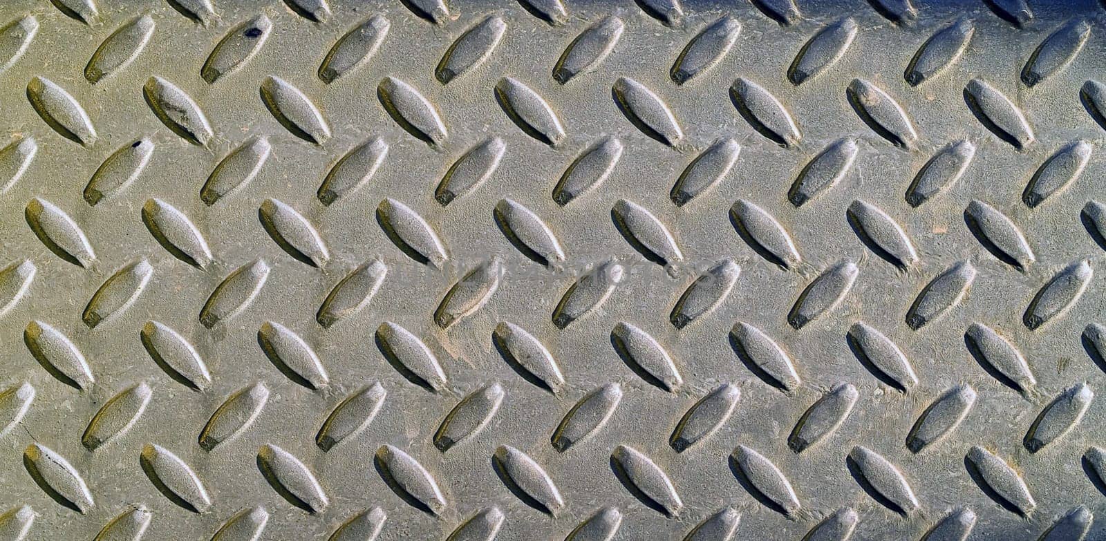 Diamond metal background texture illuminated by sunlight