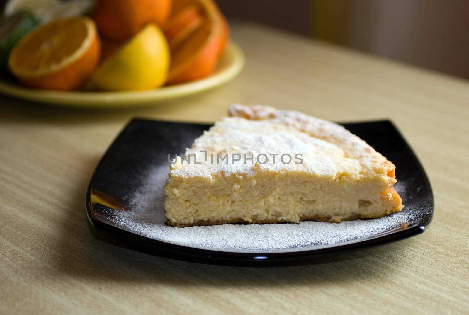 Cottage cheese cake on black plate.