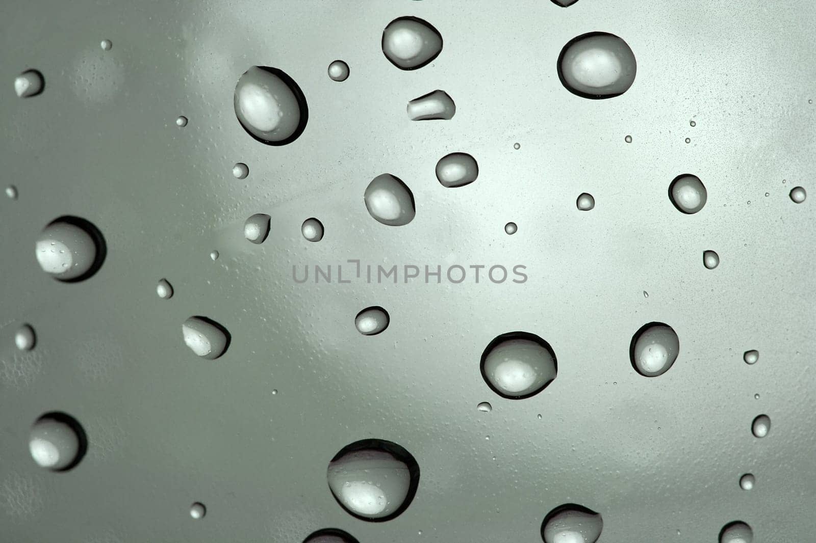 Rain drops on a gray surface