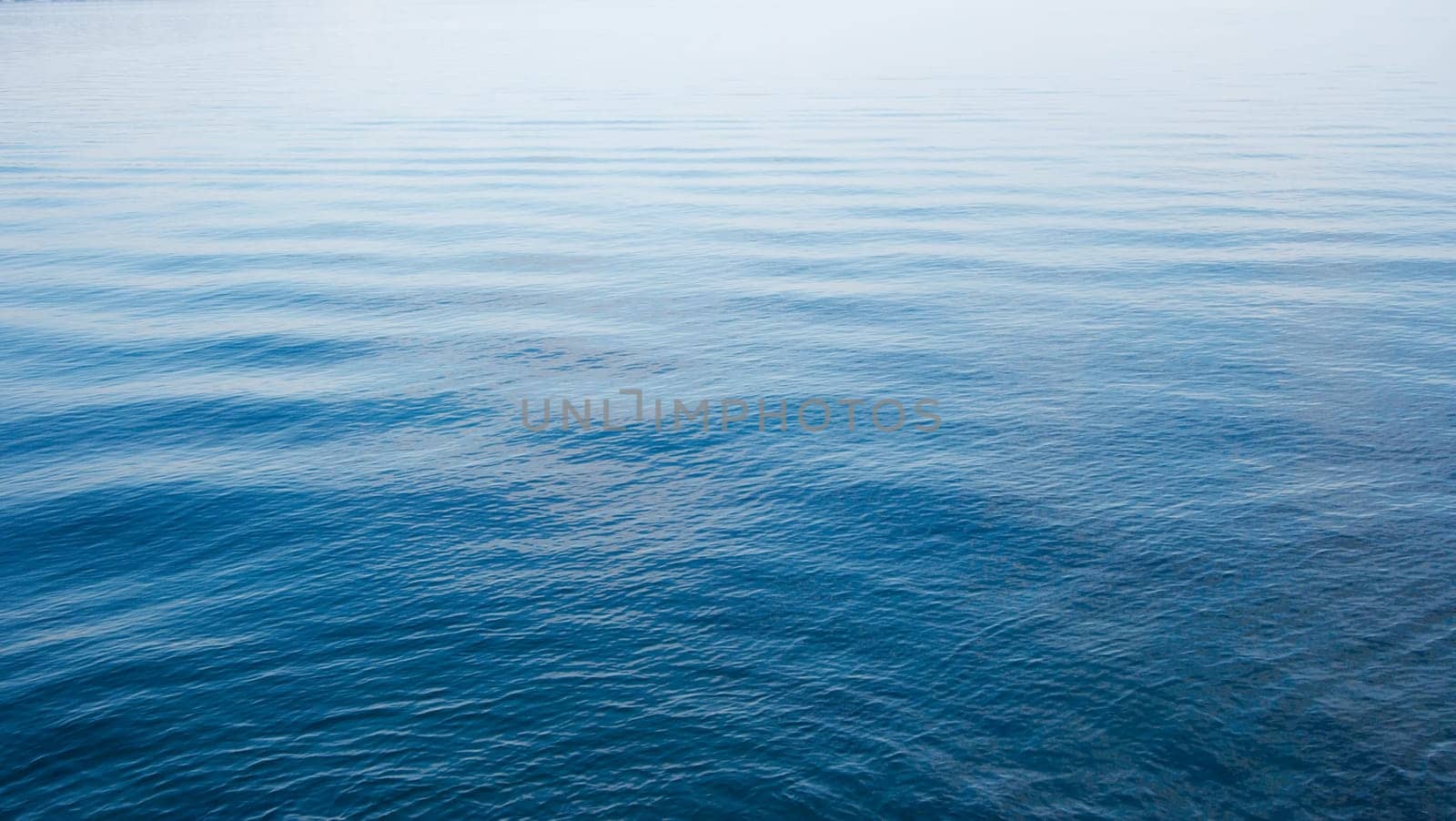 Blue water surface with small waves