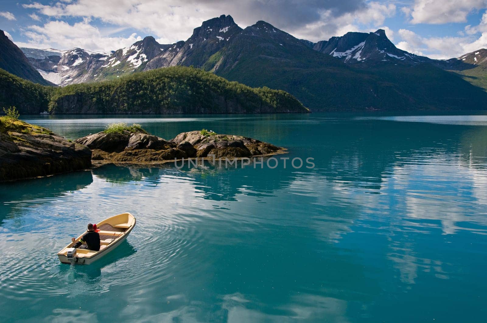 Small boat with two persons on Norwegian fjord