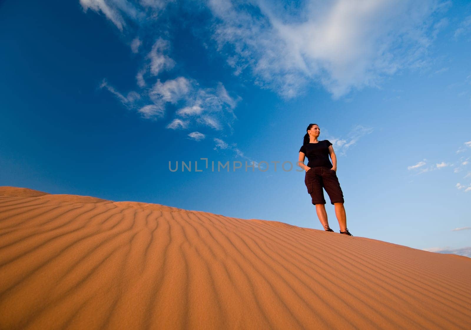 Woman admiring Coral Pink Sand Dunes State Park in Utah