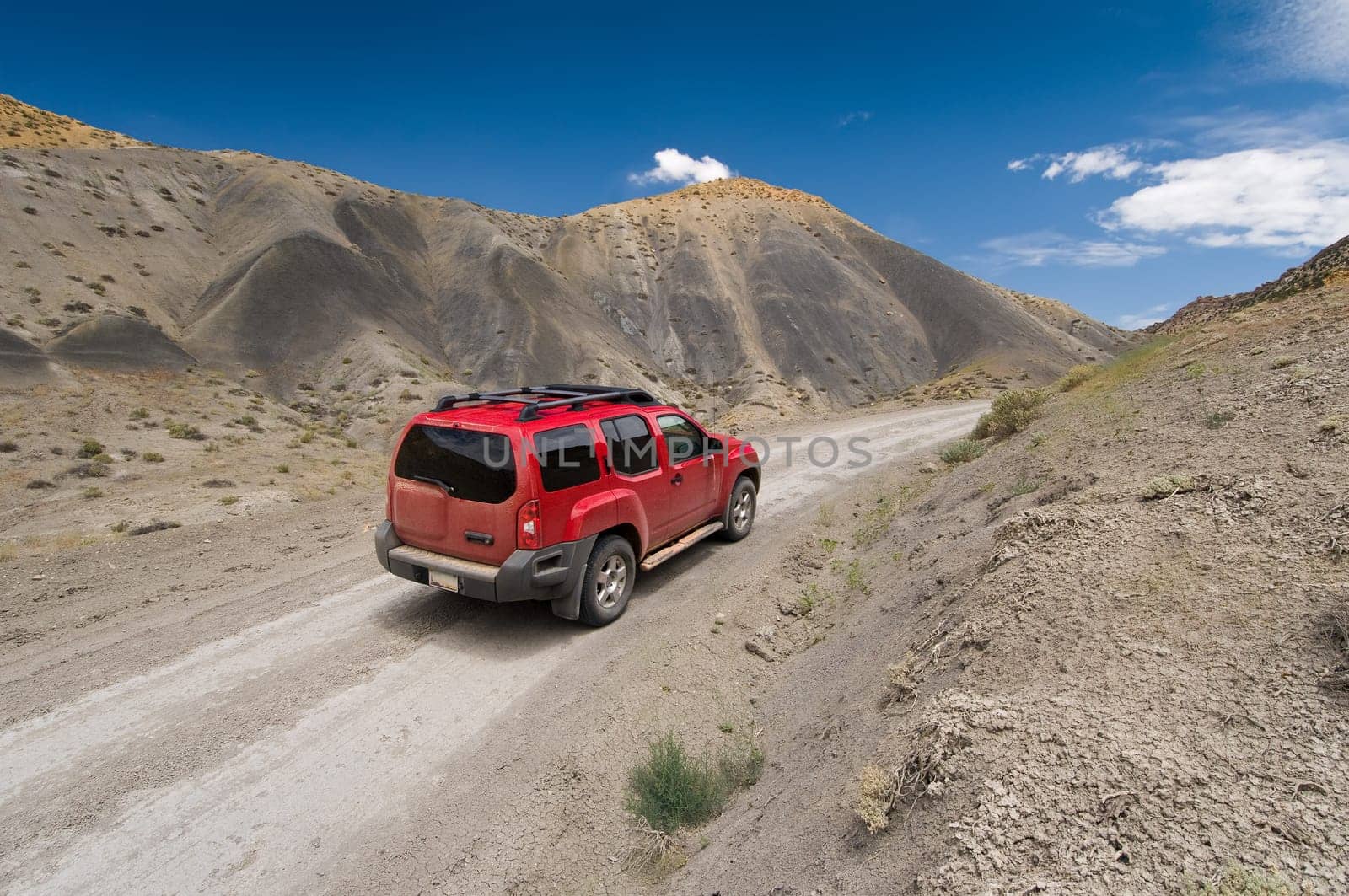 SUV driving the Cottonwood Canyon Road in Grand Staircase Escalante National Park, Utah