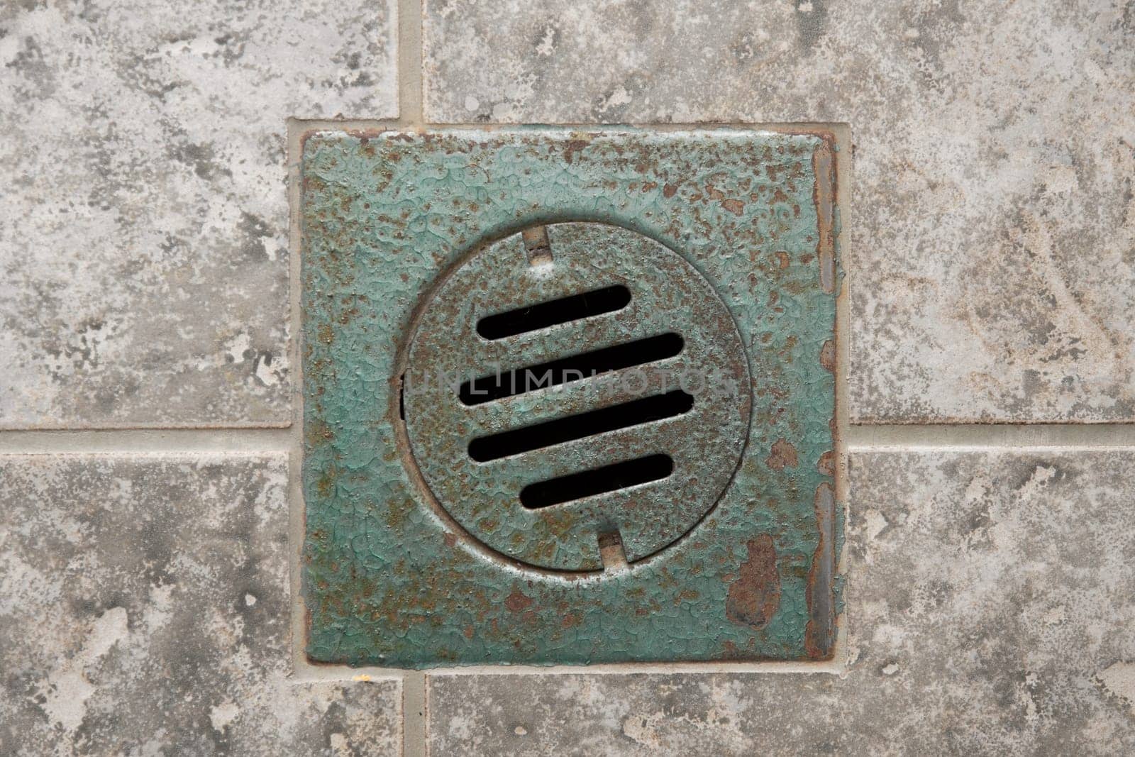 Rusty drain hole in a bathroom